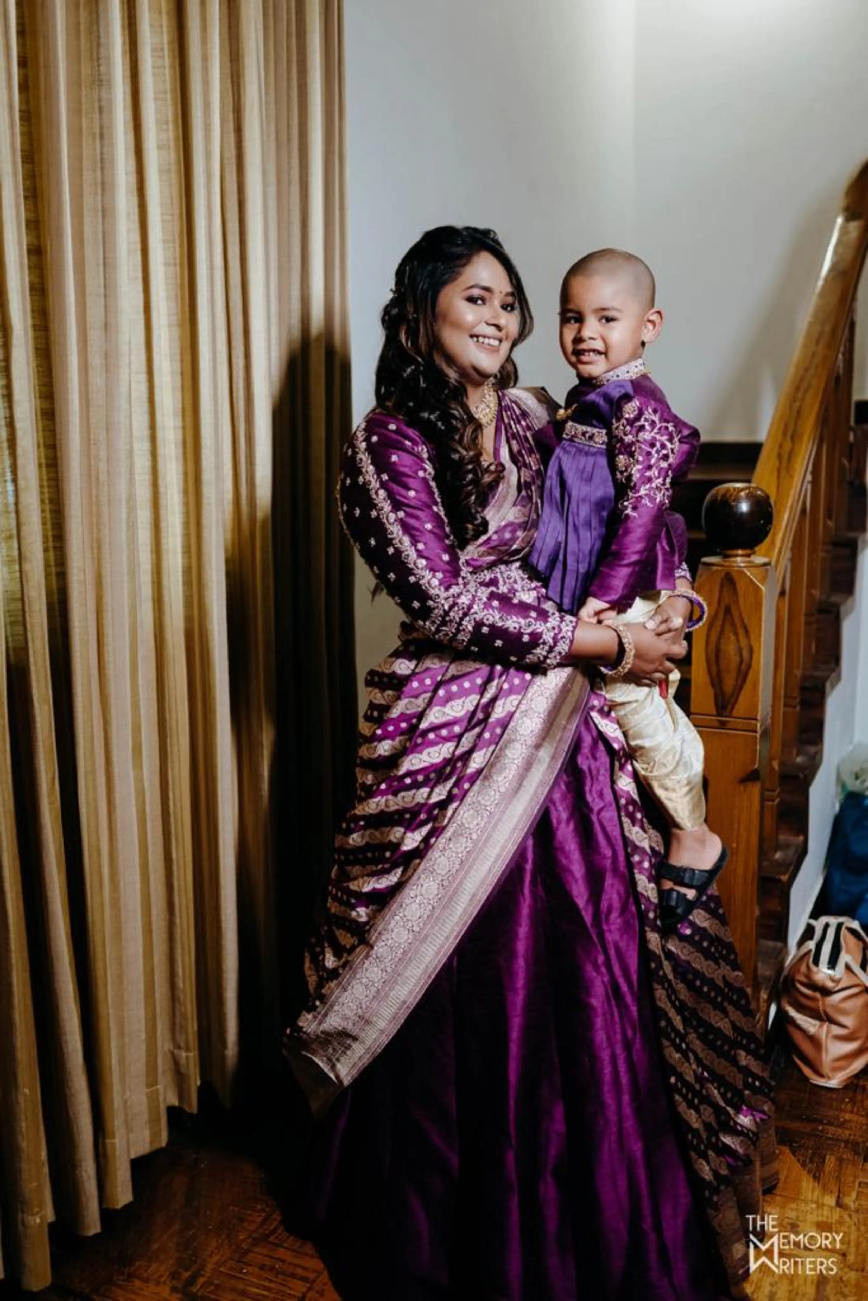 Santhoshi Babu for her son's 1st birthday in a violet silk half saree handcrafted by team Archana Karthick.