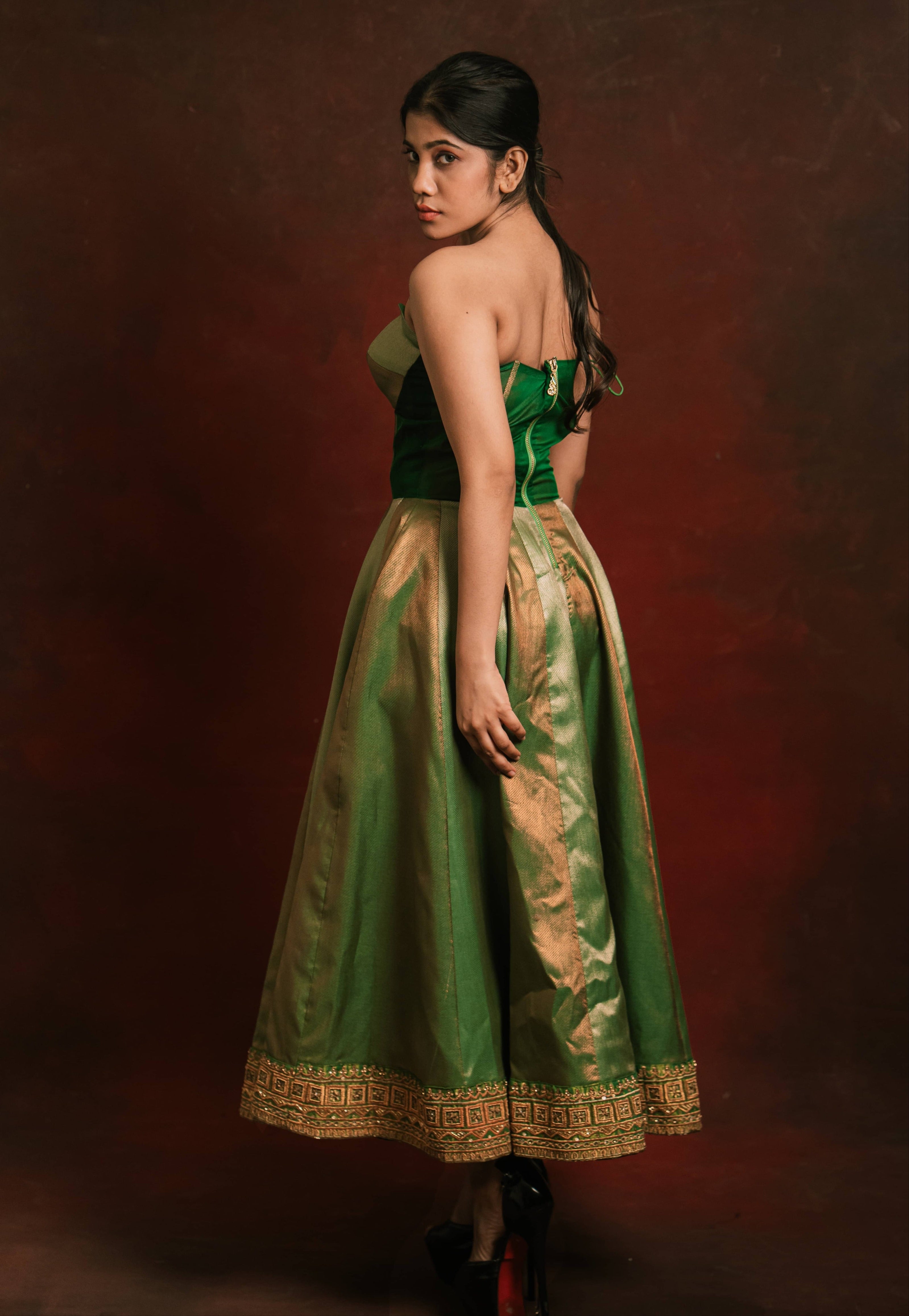 Showcasing back design in a silk corset designer dress intricately handcrafted with zari, gold beads, and antique cutdana by team Archana Karthick.