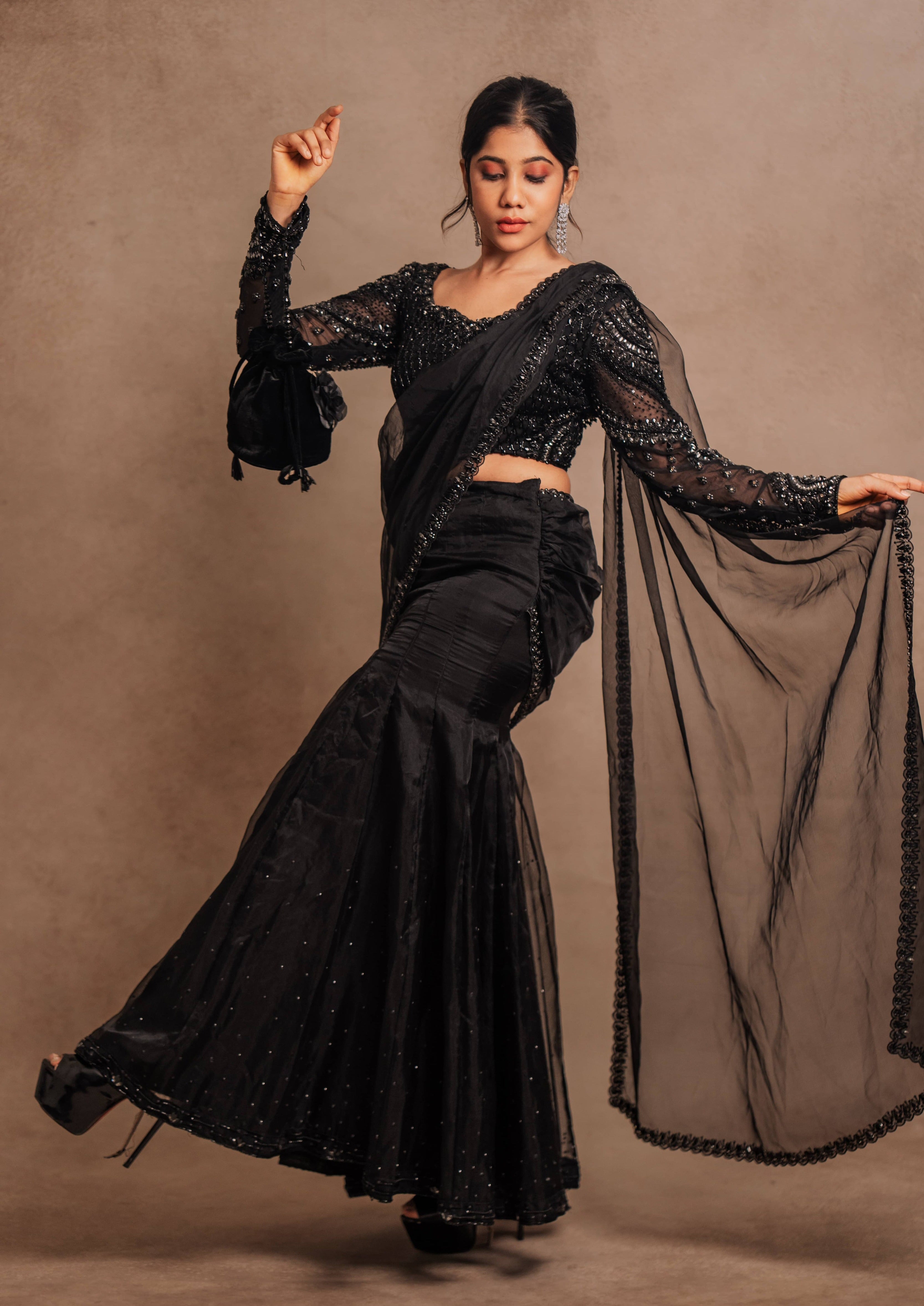 Showcasing design details in a black organza mermaid saree intricately handcrafted with stones, crystals, and sequins designed by team Archana Karthick.