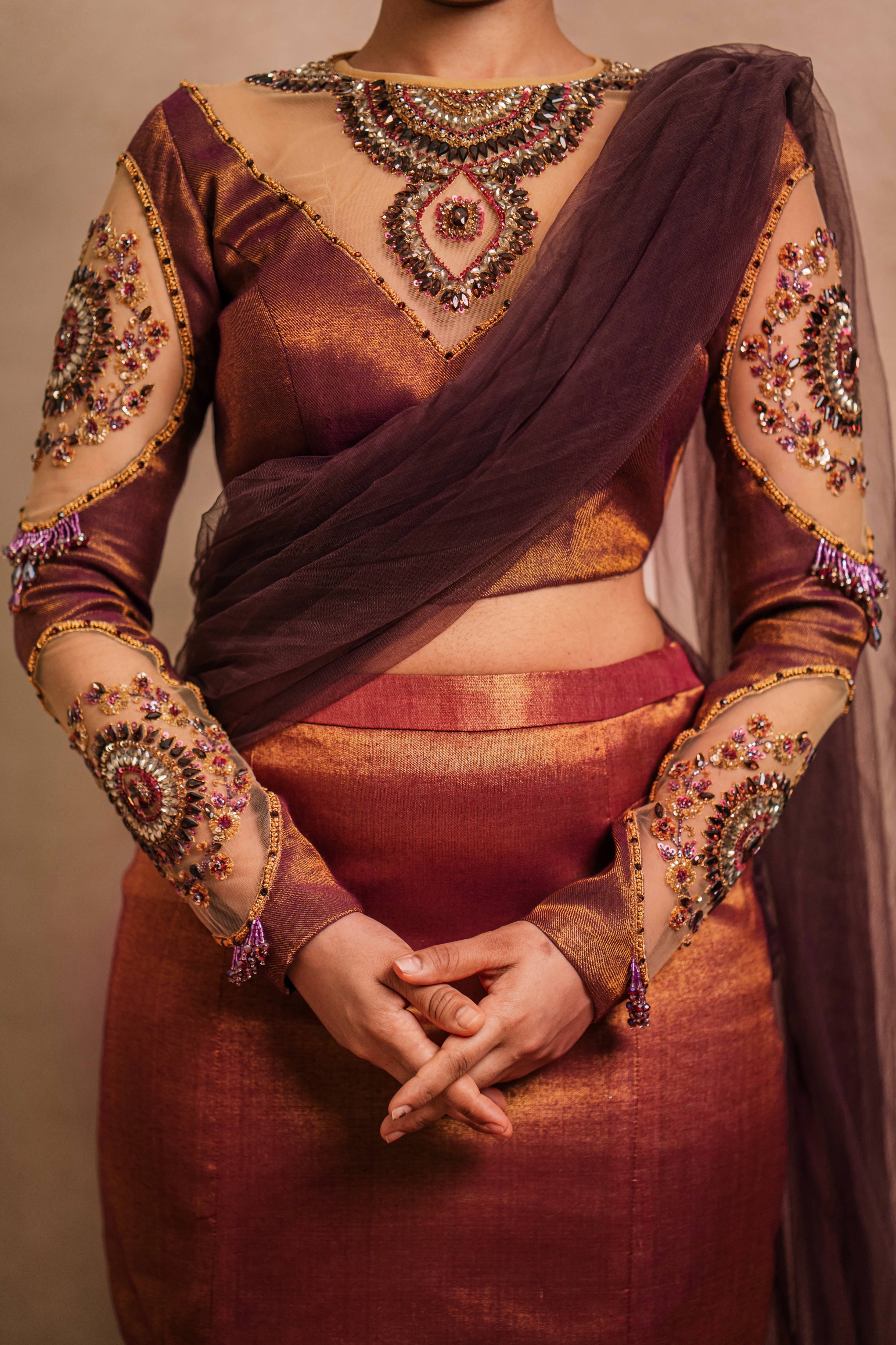 Showcasing full front profile detailings of a tissue lehenga with a mermaid skirt & a tulle dupatta intricately handcrafted with stones, crystals, and sequins by team Archana Karthick.