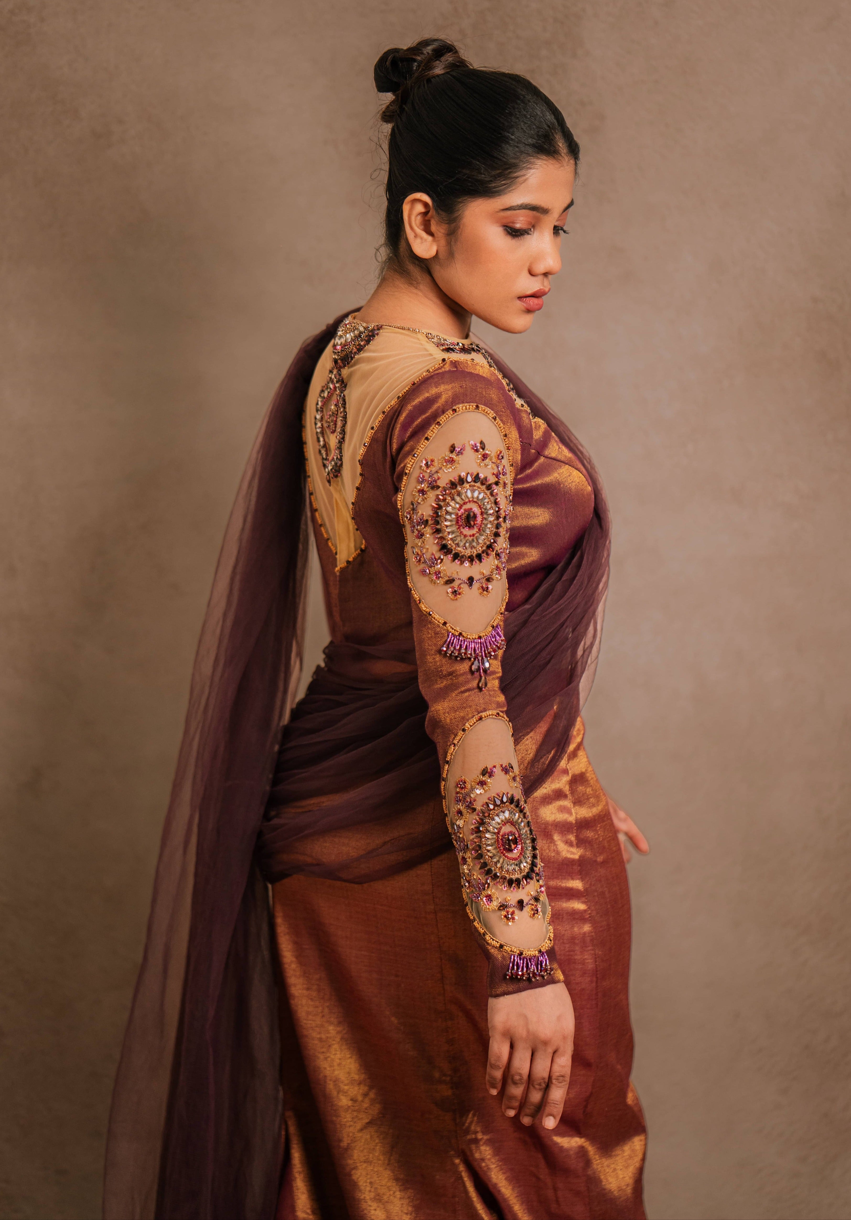 Showcasing sleeves in a tissue lehenga with a mermaid skirt & a tulle dupatta intricately handcrafted with stones, crystals, and sequins by team Archana Karthick.