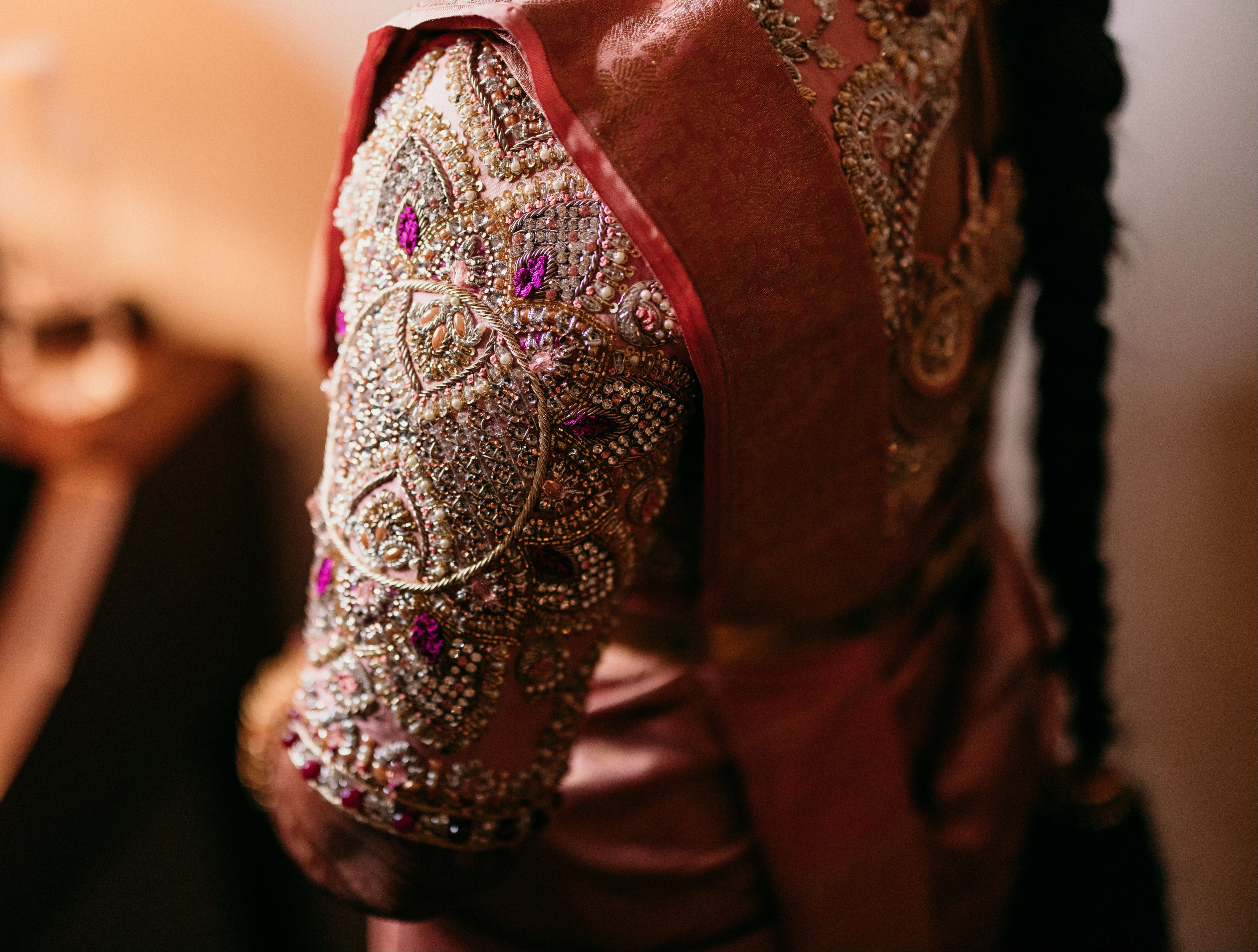 Sleeves of a palanquin concept pink blouse handcrafted intricately with resham knot work, cut dana, crystal, pearls, swarovski stones and sequins designed by Archana Karthick.