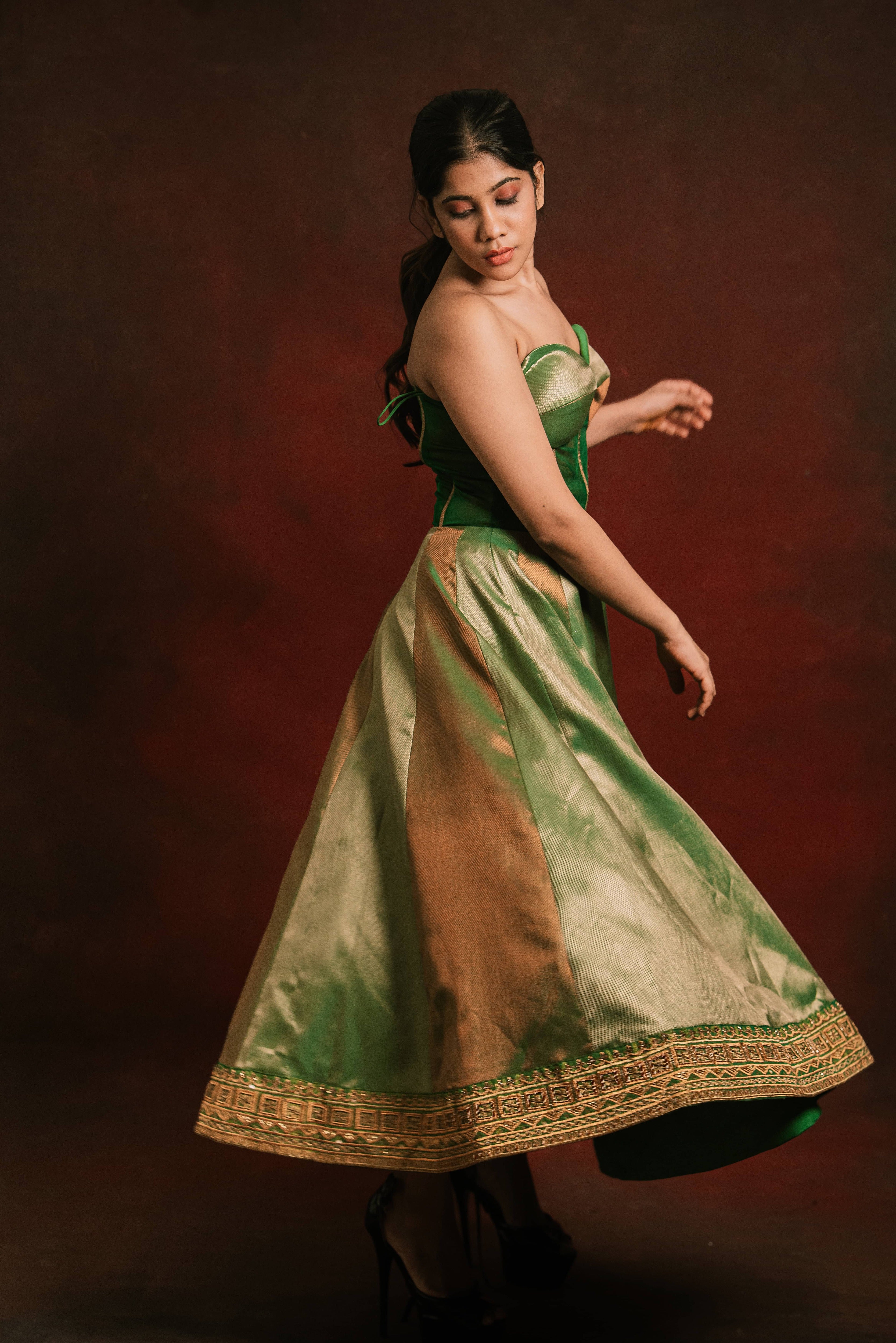 Twirling with a silk corset designer dress intricately handcrafted with zari, gold beads, and antique cutdana by team Archana Karthick.