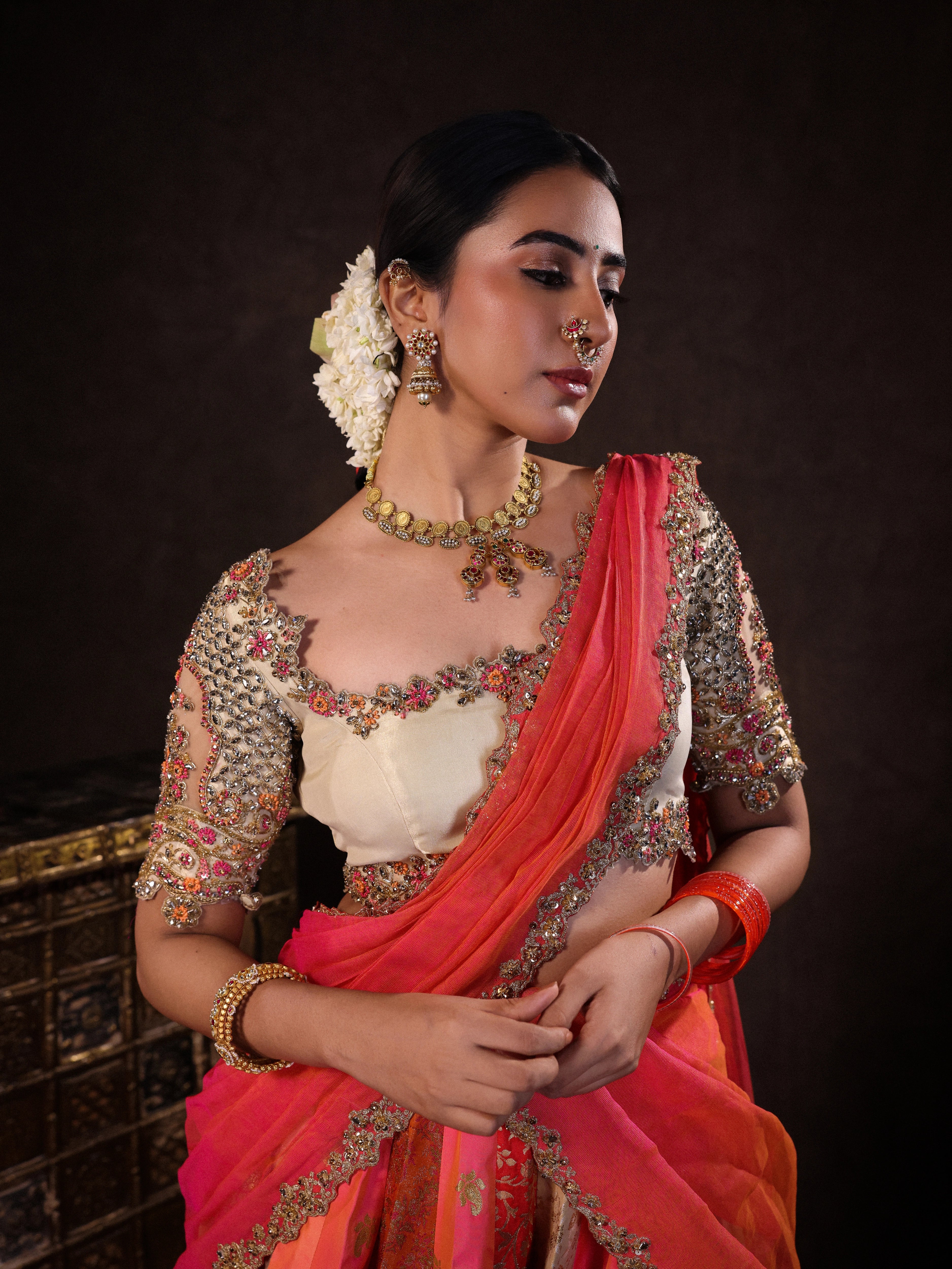 Actress Akshaya Hariharan in pink and ivory banarasi brocade silk half saree blouse with glass bangles and NAC jewellery.