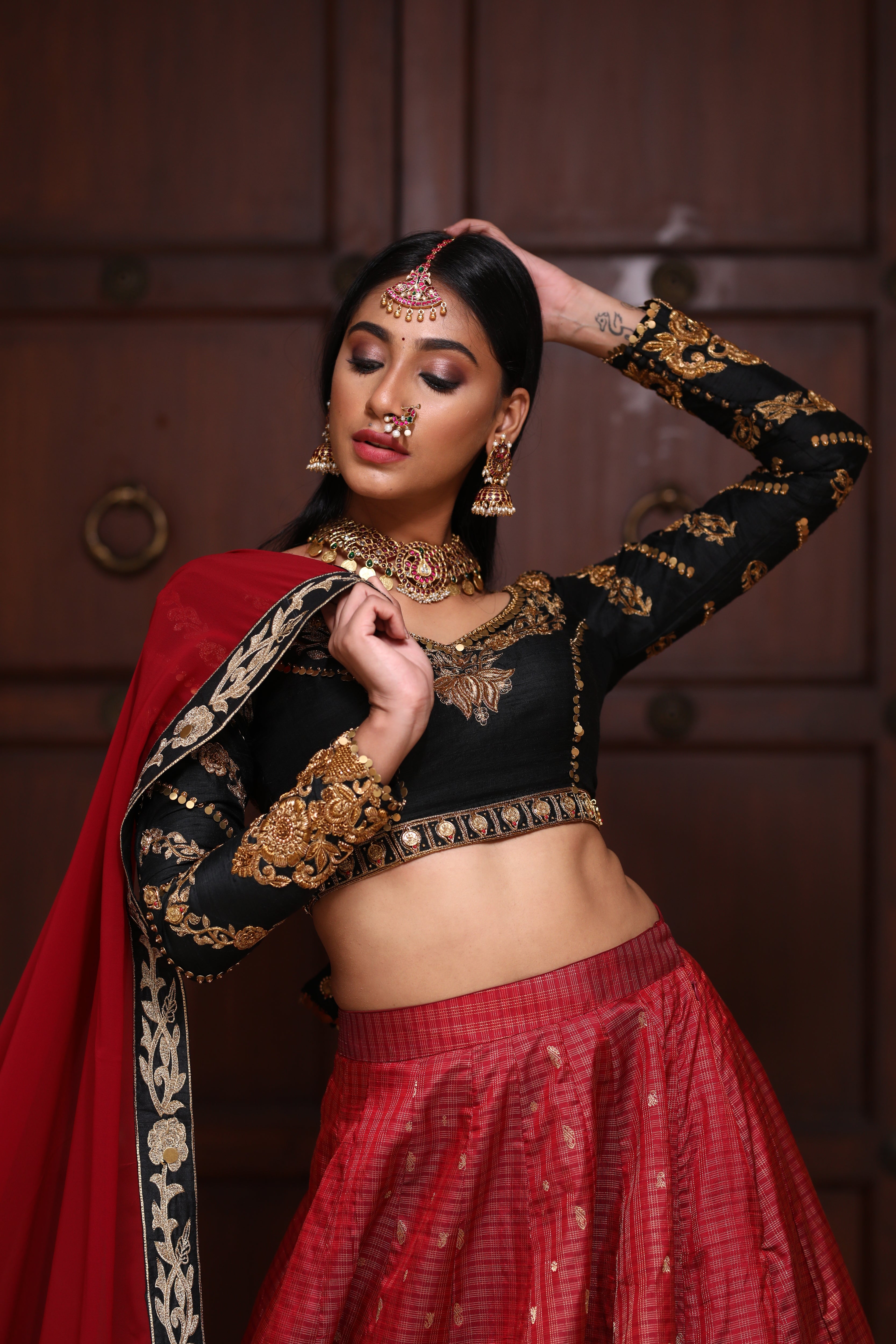 miss india 2018 and actress Anukreethy Vas in lehenga designed by archana karthick posing hand on back of head front half