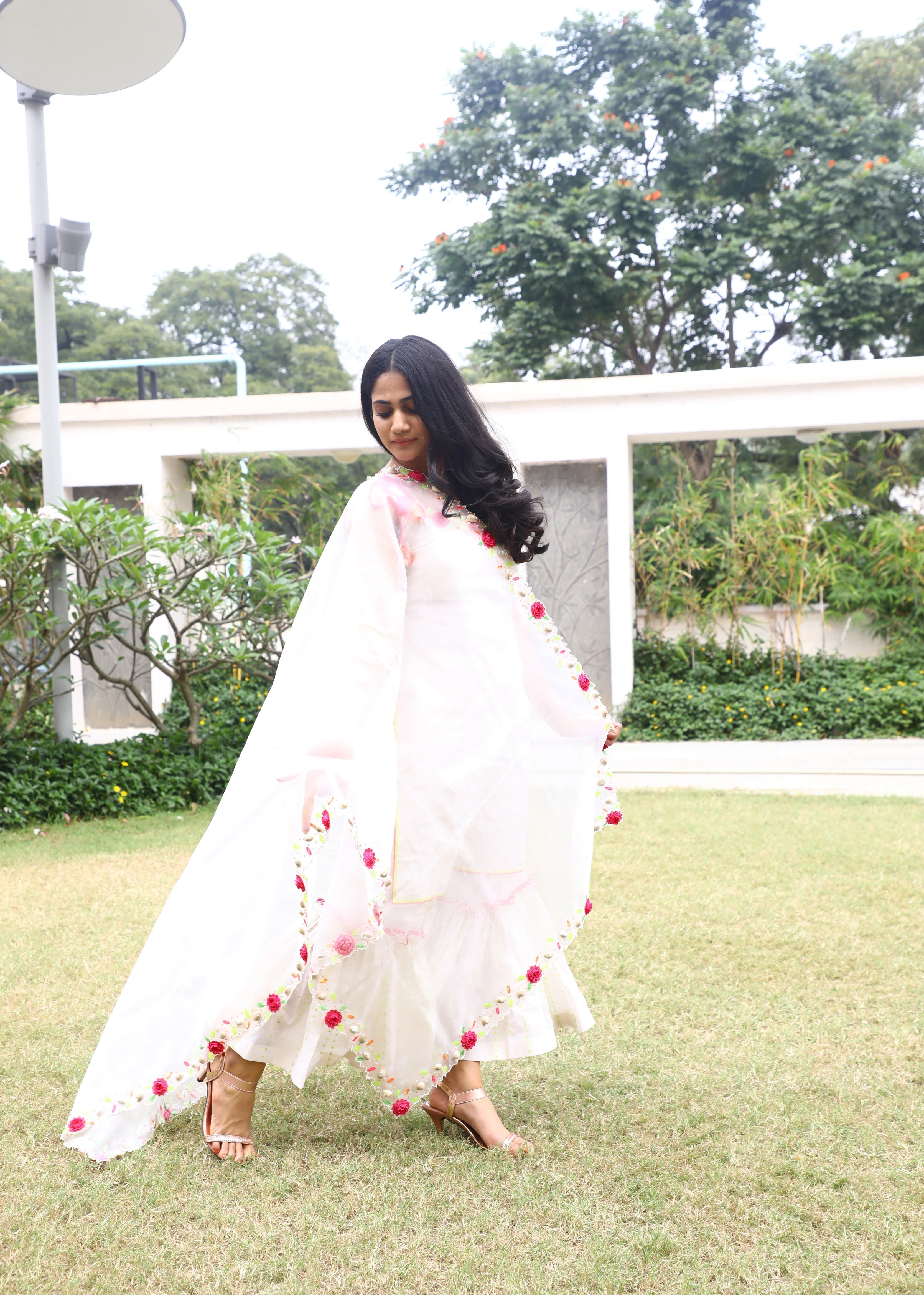 Actor and Influencer Losliya Mariyanesan showcasing dupatta in a gharara set handcrafted with handmade 3D Flowers, pom poms and sea shells. Designed by Archana Karthick