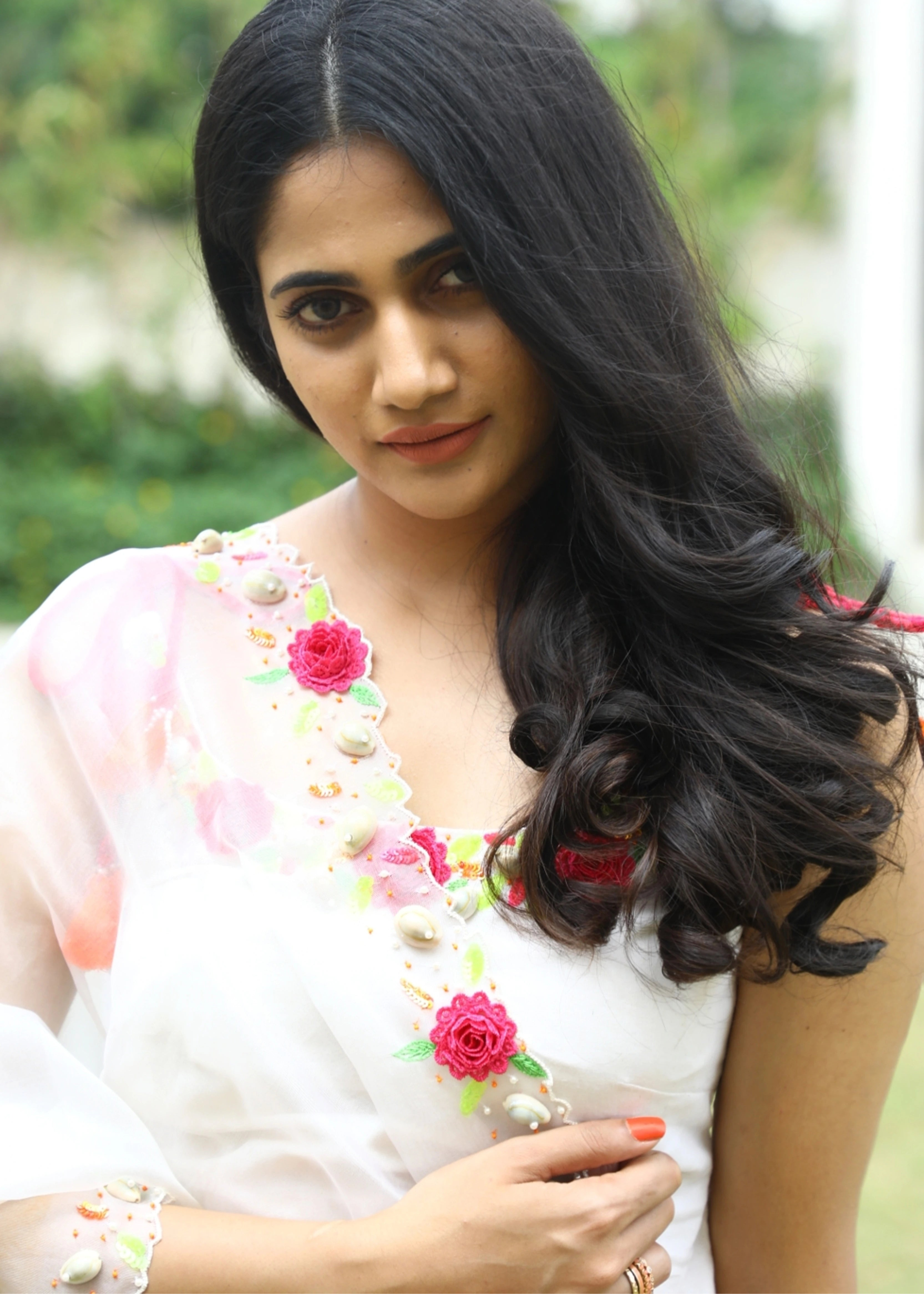 Actor and Influencer Losliya Mariyanesan showcasing front design in a gharara set handcrafted with handmade 3D Flowers, pom poms and sea shells. Designed by Archana Karthick