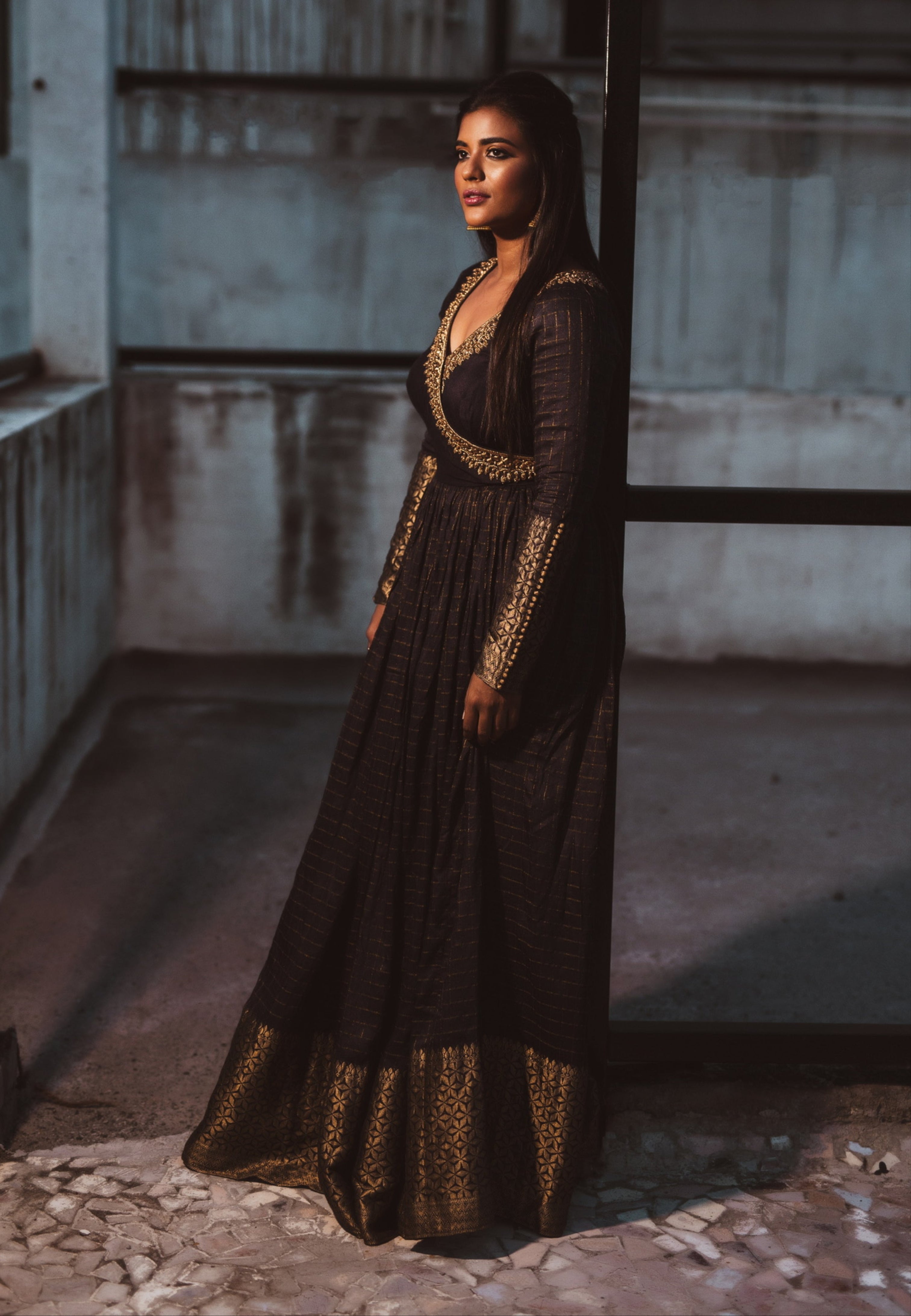 Actress Aishwarya Rajesh in a black silk angrakha anarkali looking away from camera with a smile