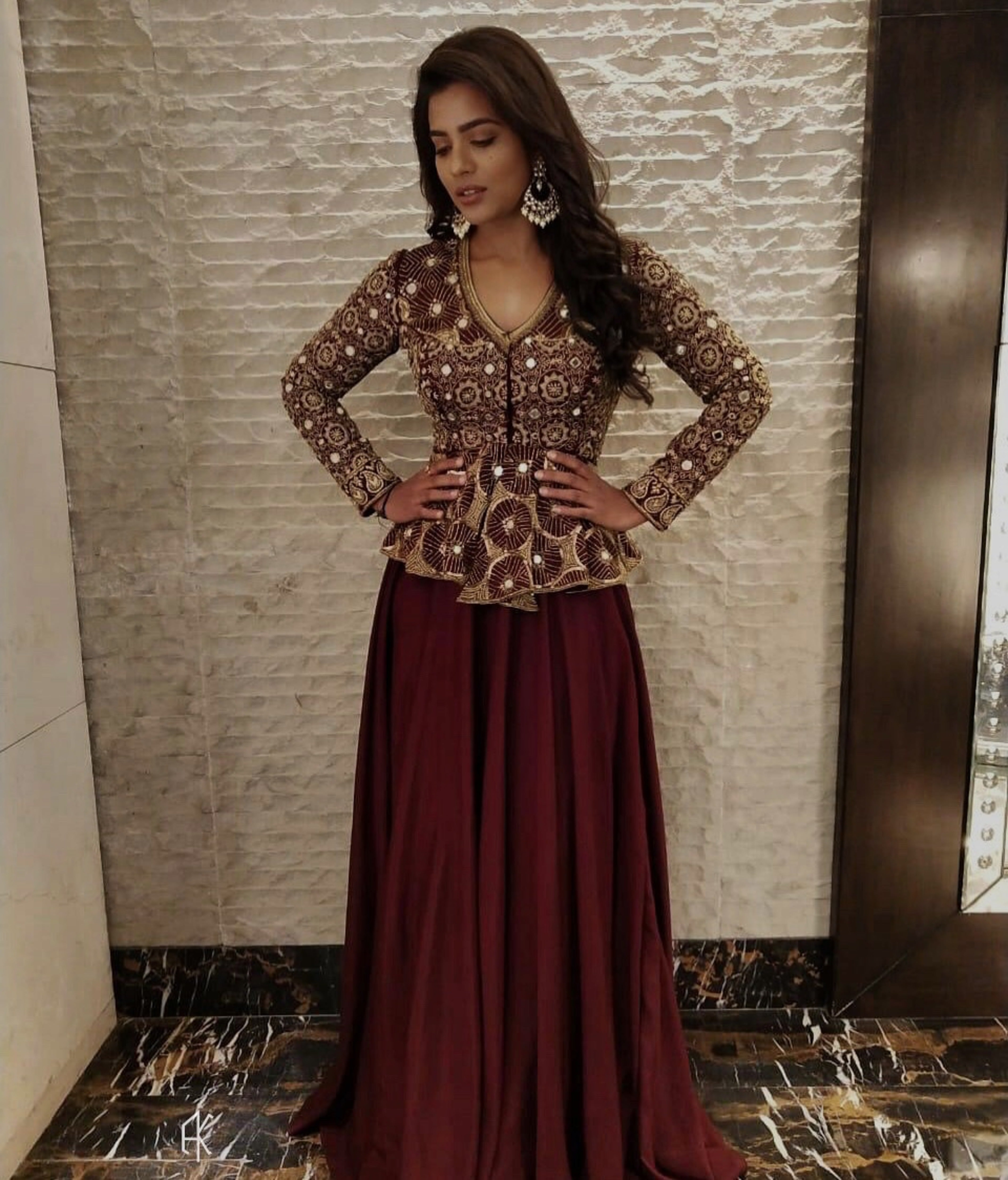 Actress Aishwarya Rajesh in a handcrafted peplum sharara in wine red for the promo of the movie world famous lover with vijay devarakonda
