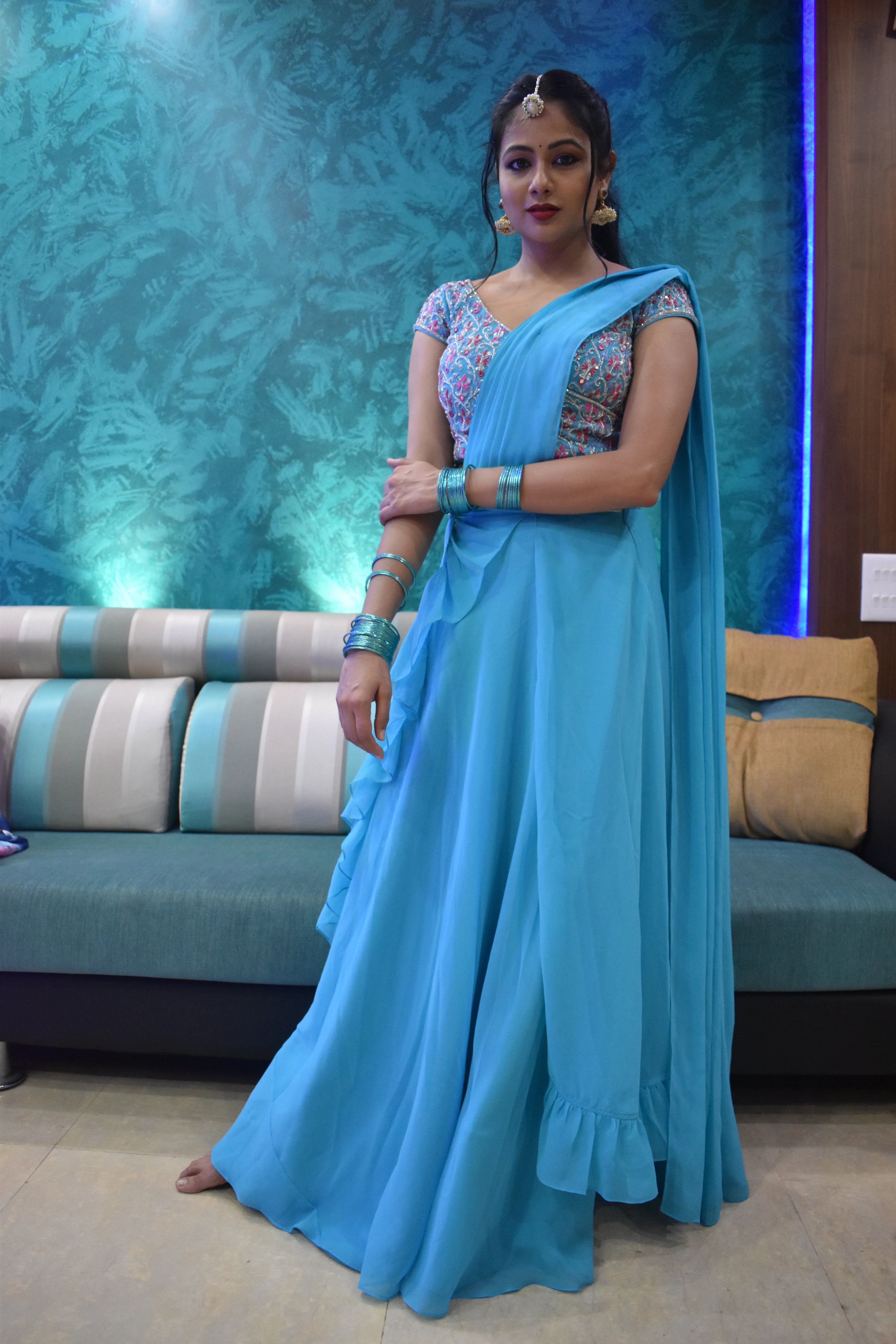 Actress Archita Sahu posing in a blue georgette draped lehenga, intricately handcrafted with sequins, mirror, cutdana and resham by team Archana Karthick.