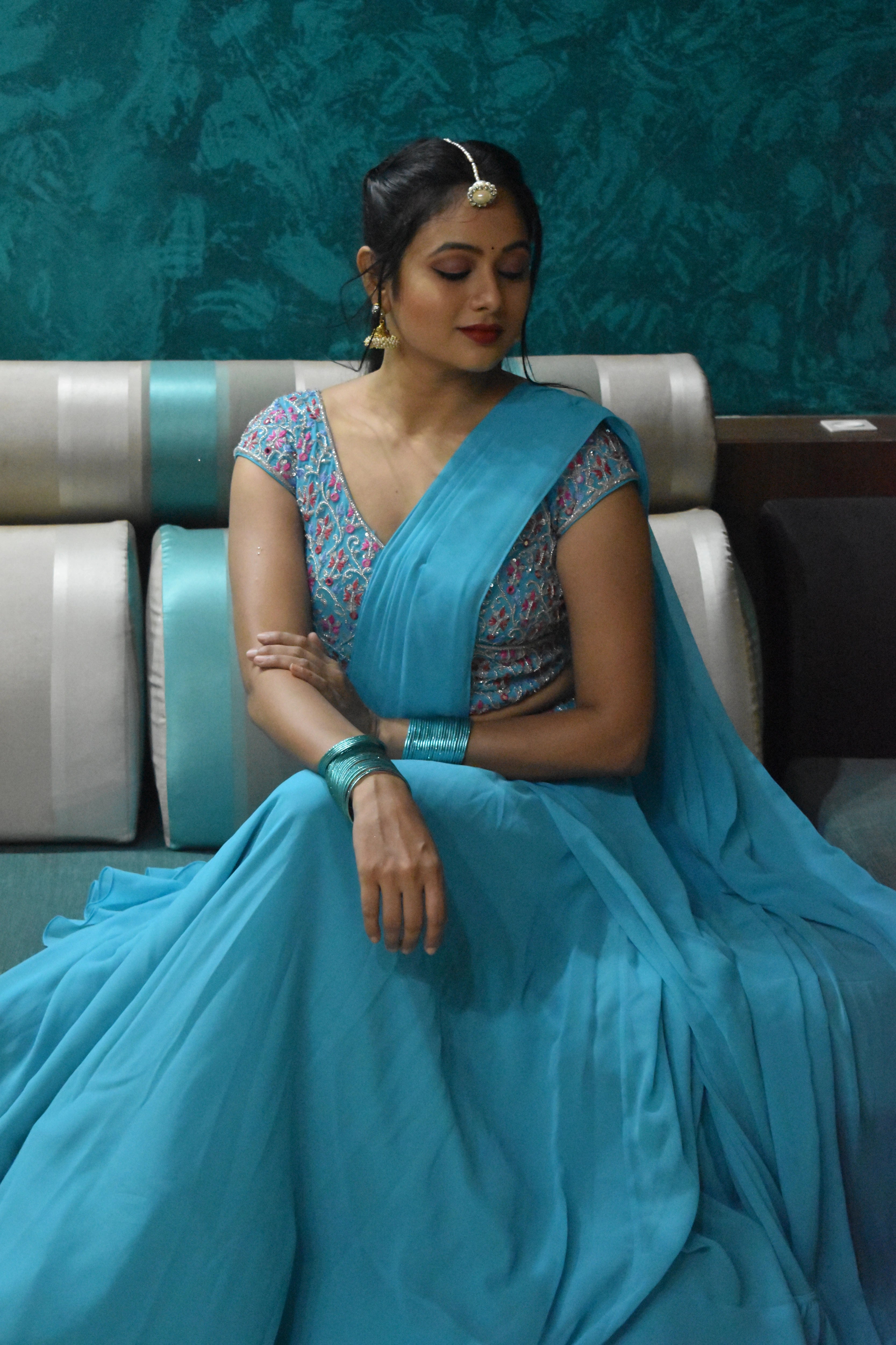 Actress Archita Sahu smiling in a blue georgette draped lehenga, intricately handcrafted with sequins, mirror, cutdana and resham by team Archana Karthick.