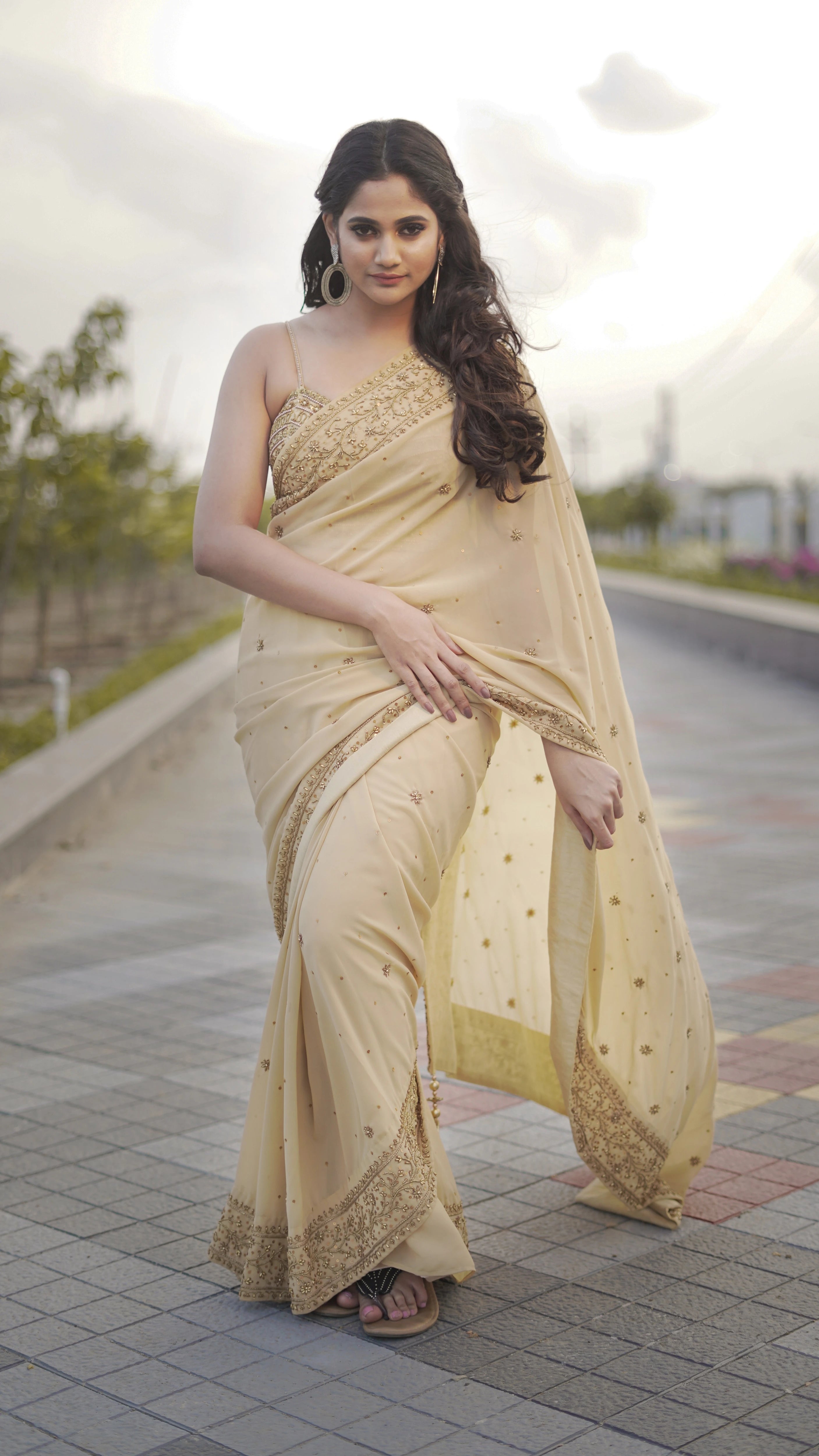 Actress & Bigg Boss fame Losliya during photoshoot in a beige georgette saree paired with a bralette, handcrafted with beads, sequins and pearls by team Archana Karthick.