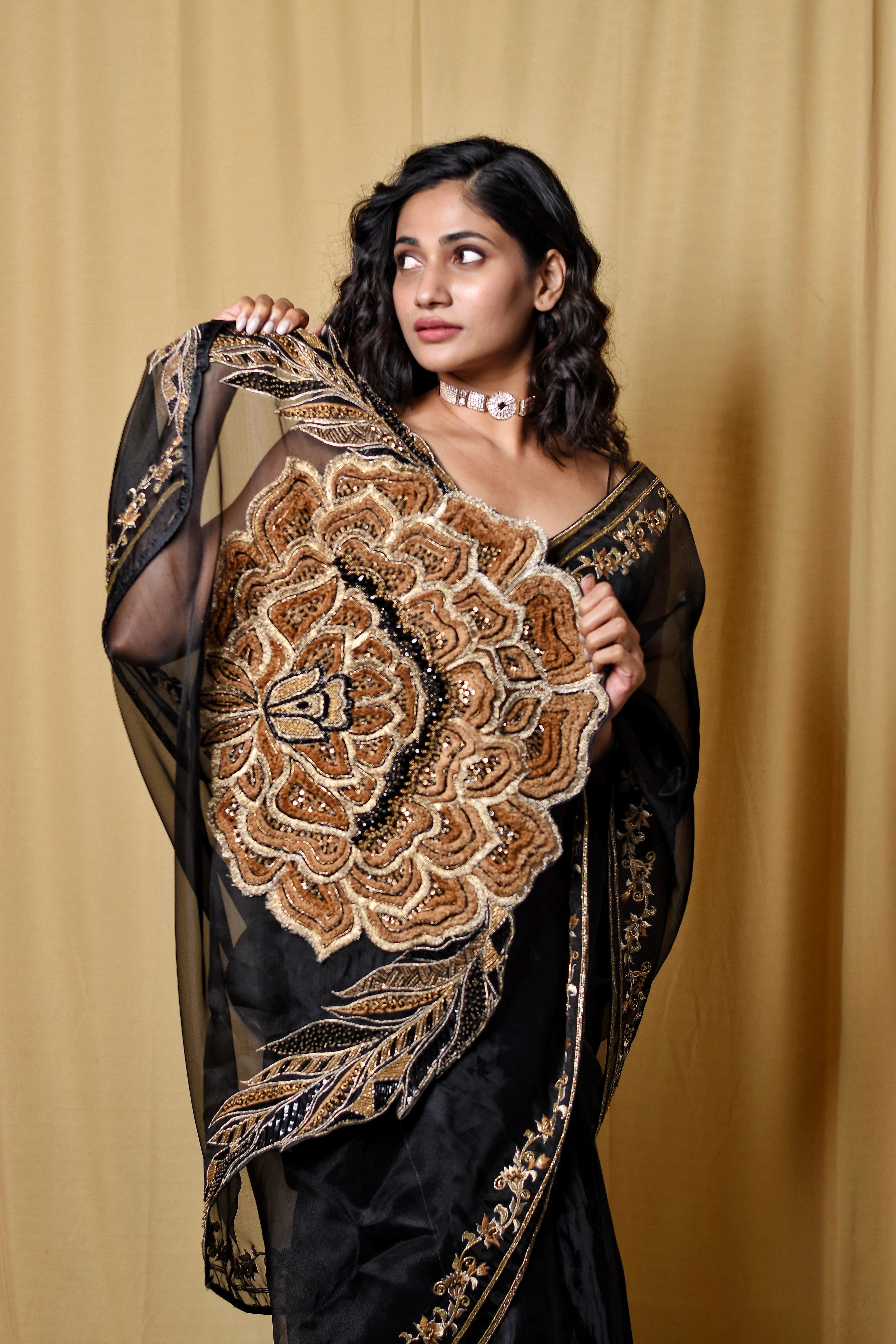 Actress & Bigg Boss fame Losliya posing in a black organza saree, intricately handcrafted with cutdana, zari, beads, sequins and resham by team Archana Karthick.