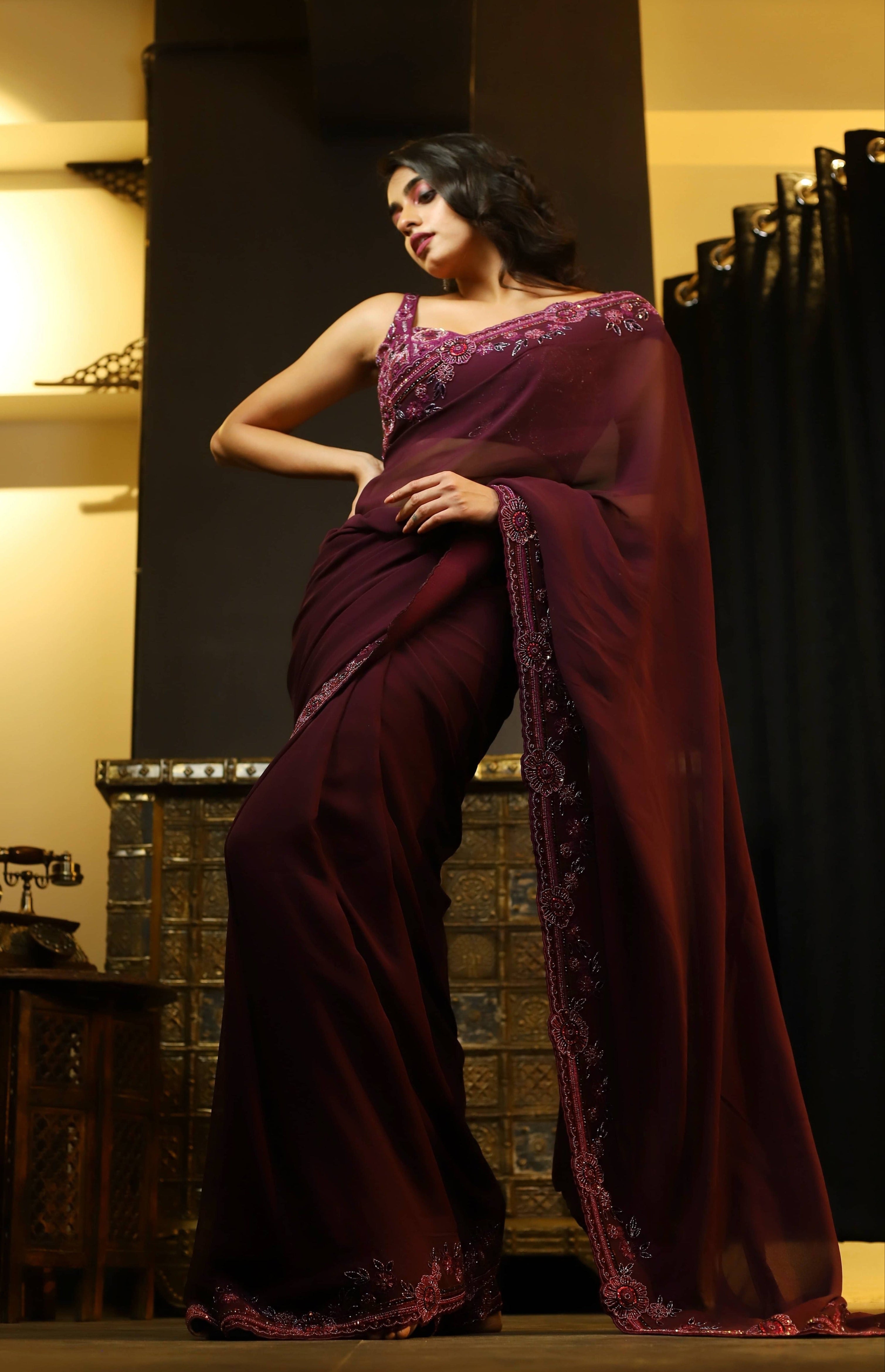 Actress Cherukuri Maanasa Choudhary who acted in the movie Lucky Baskhar with Dulquer Salmaan is seen here in an eggplant aubergine colored georgette saree and embellished blouse. saree border design