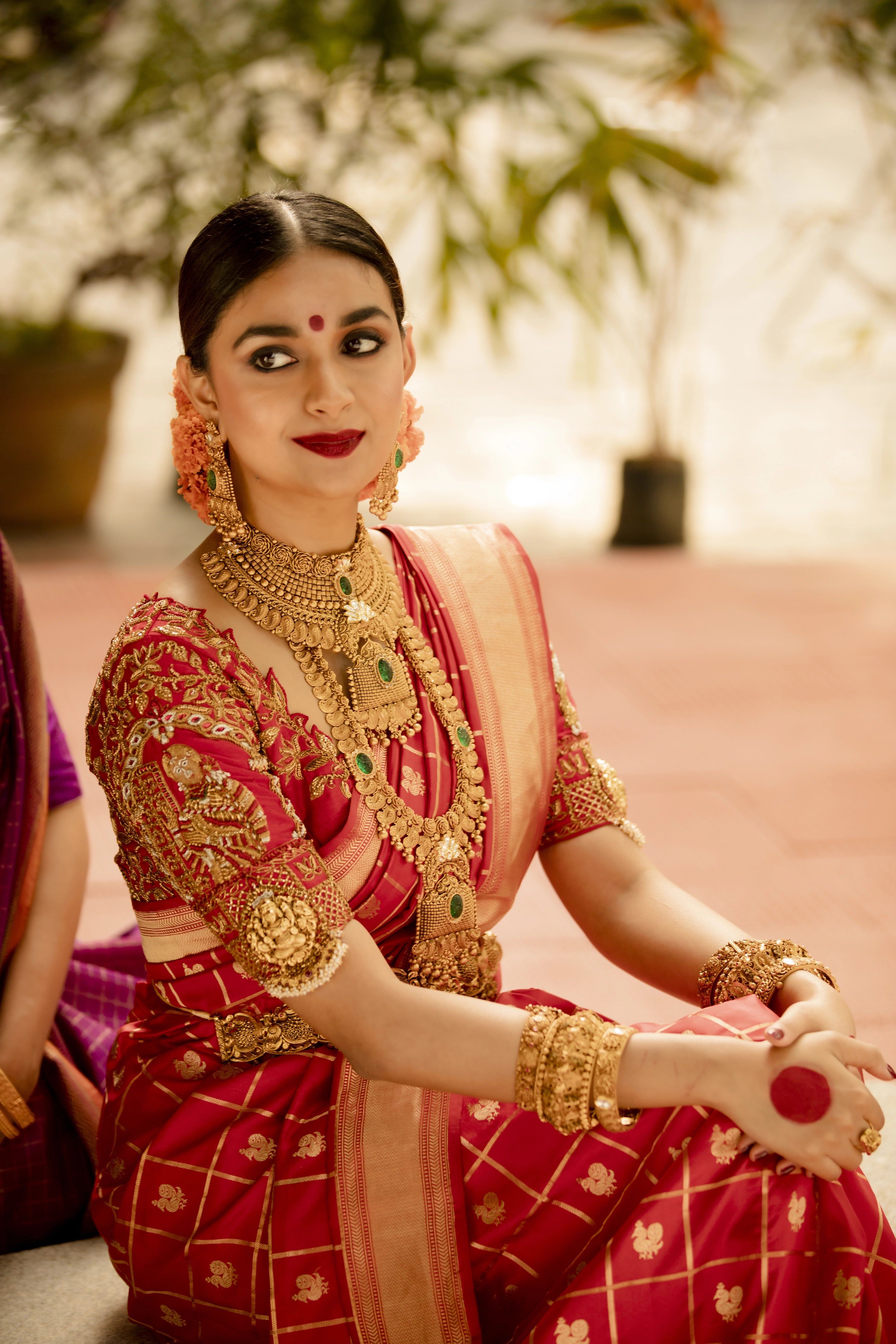 Actress Keerthy Suresh in a red raw silk palanquin concept blouse handcrafted by team Archana Karthick.