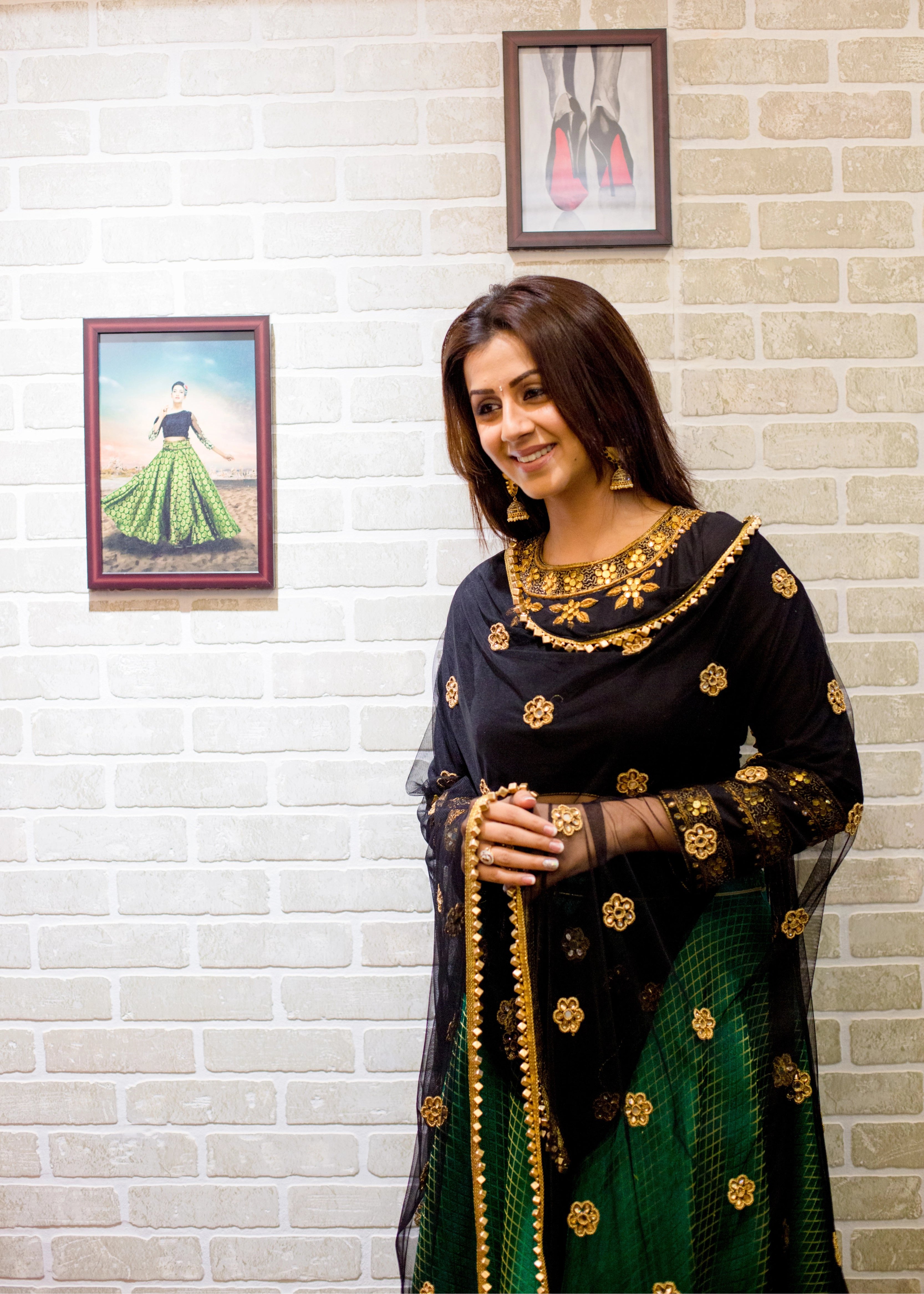 Actress Nikki Galrani smiling in a lehenga designed by Archana Karthick with gota, mirror, cutdana, zardozi and metallic cubes on the border of the tulle dupatta.