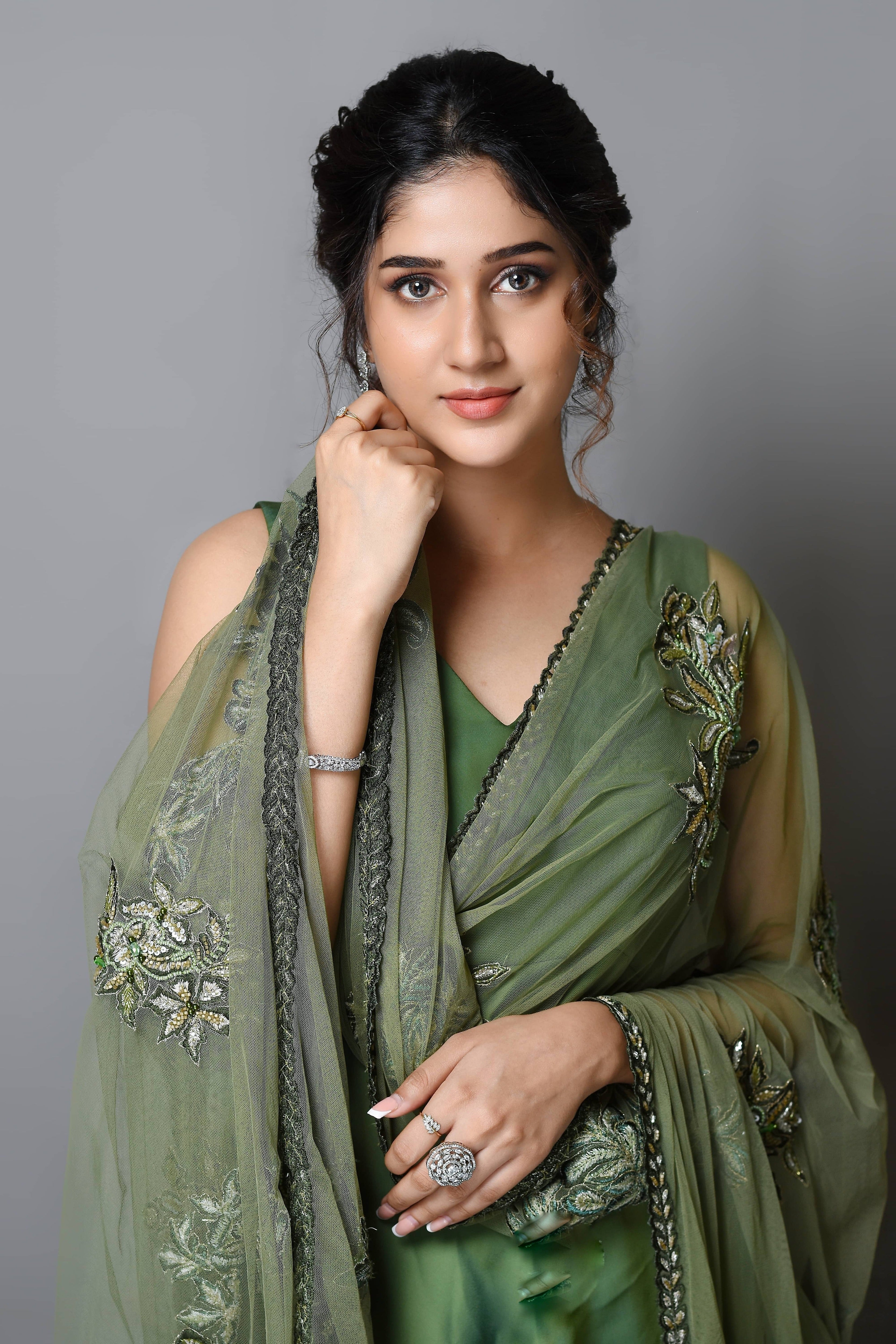 Actress Rabiya Khatoon in a green satin georgette peplum sharara palazzo set with embellished dupatta. Closeup picture.