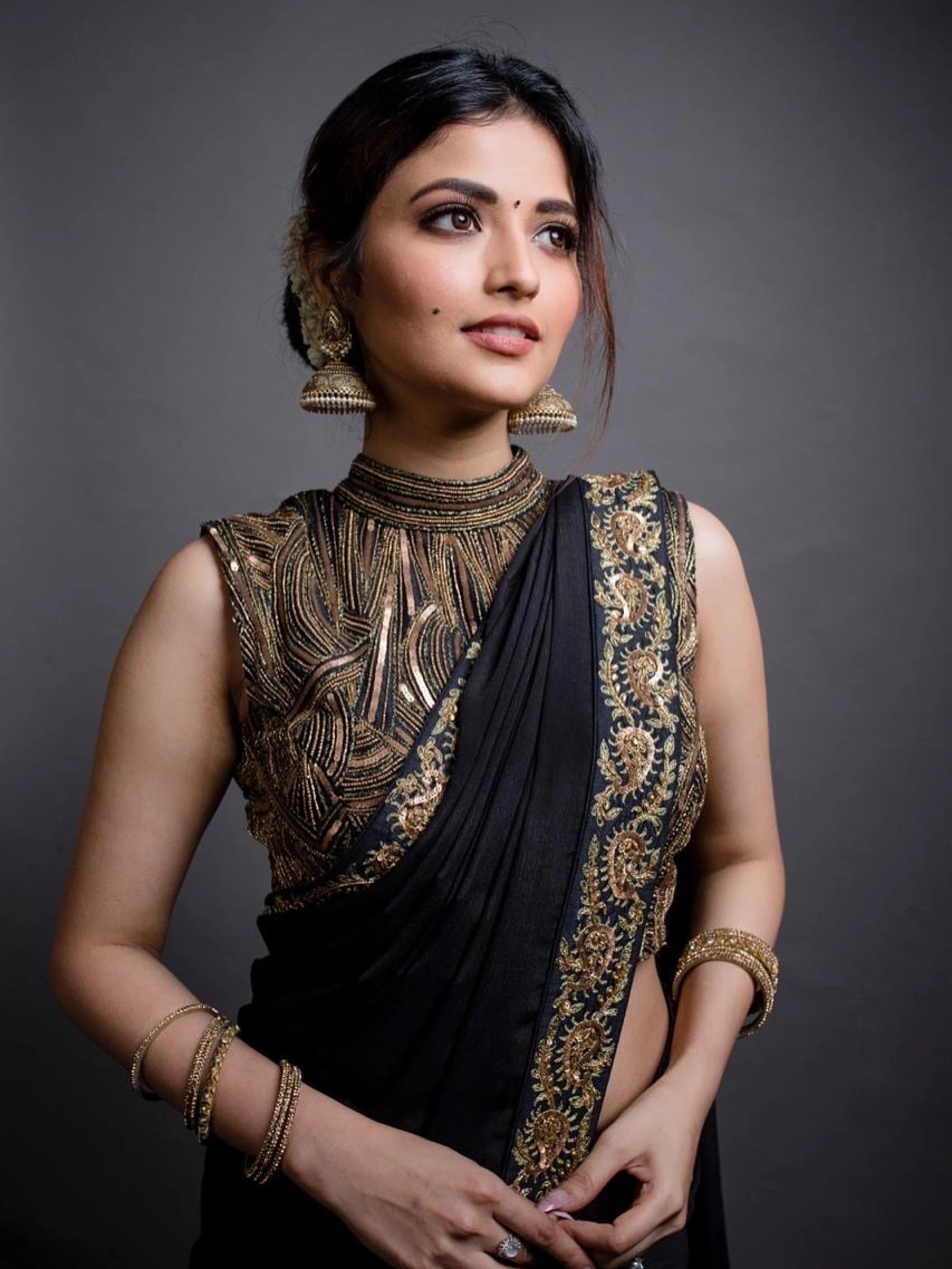 Actress Shirin Kanchwala posing in a crepe silk black saree intricately handcrafted with zardozi, sequins and dori work by team Archana Karthick.