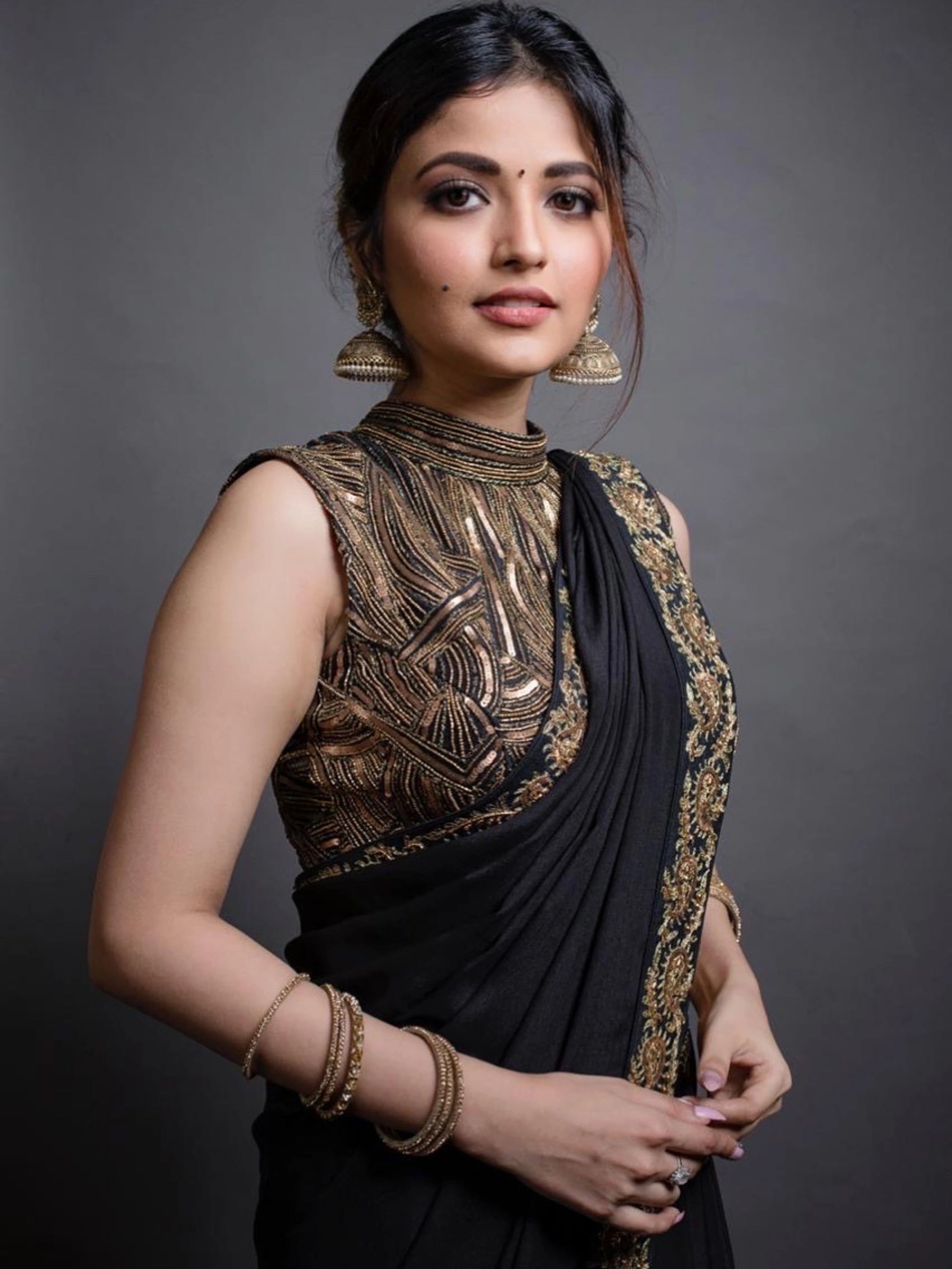 Actress Shirin Kanchwala smiles in a crepe silk black saree intricately handcrafted with zardozi, sequins and dori work by team Archana Karthick.