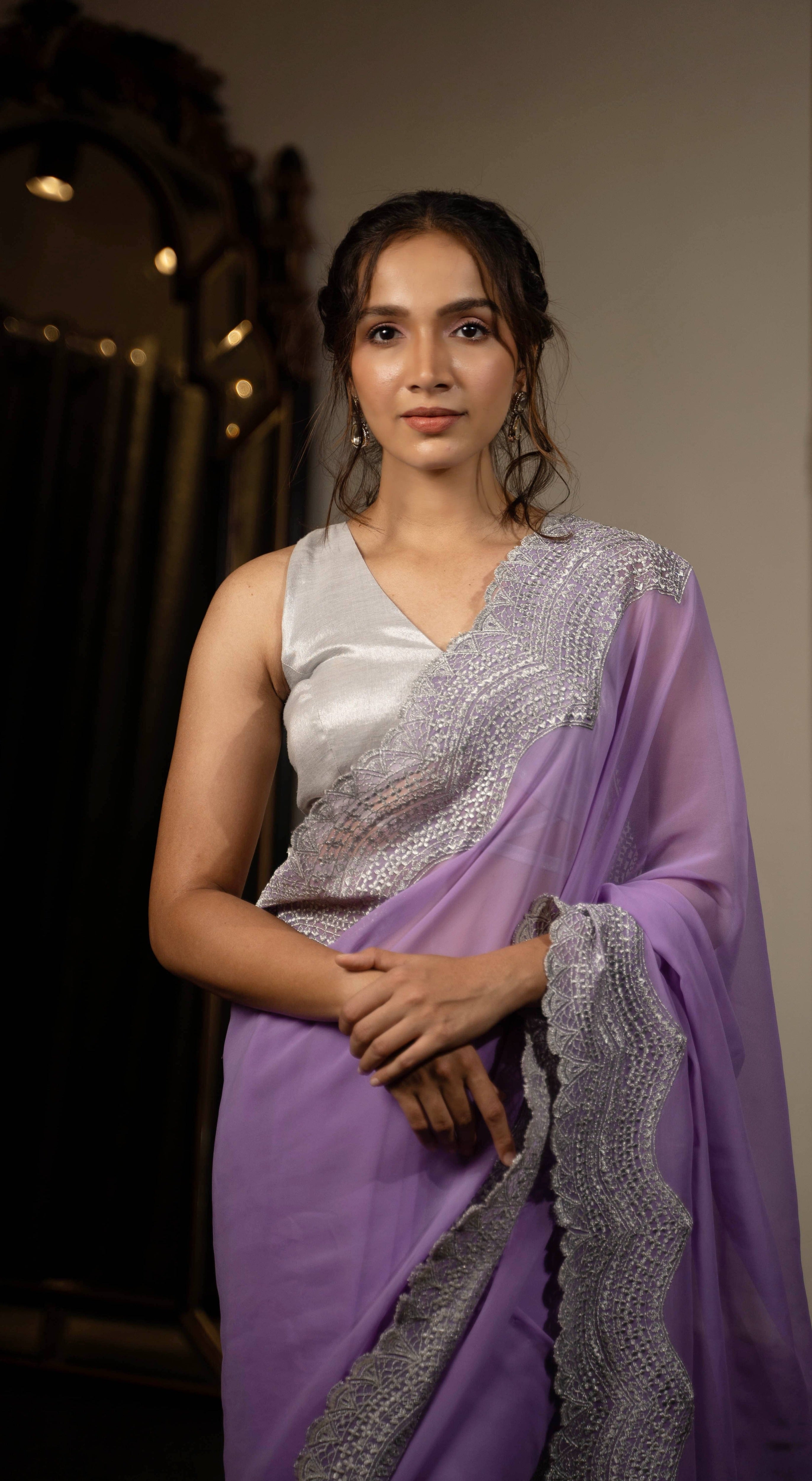 Actress and fitness influencer Shweta Gai in lavender chiffon saree with silver waist tie up blouse posing straight at camera