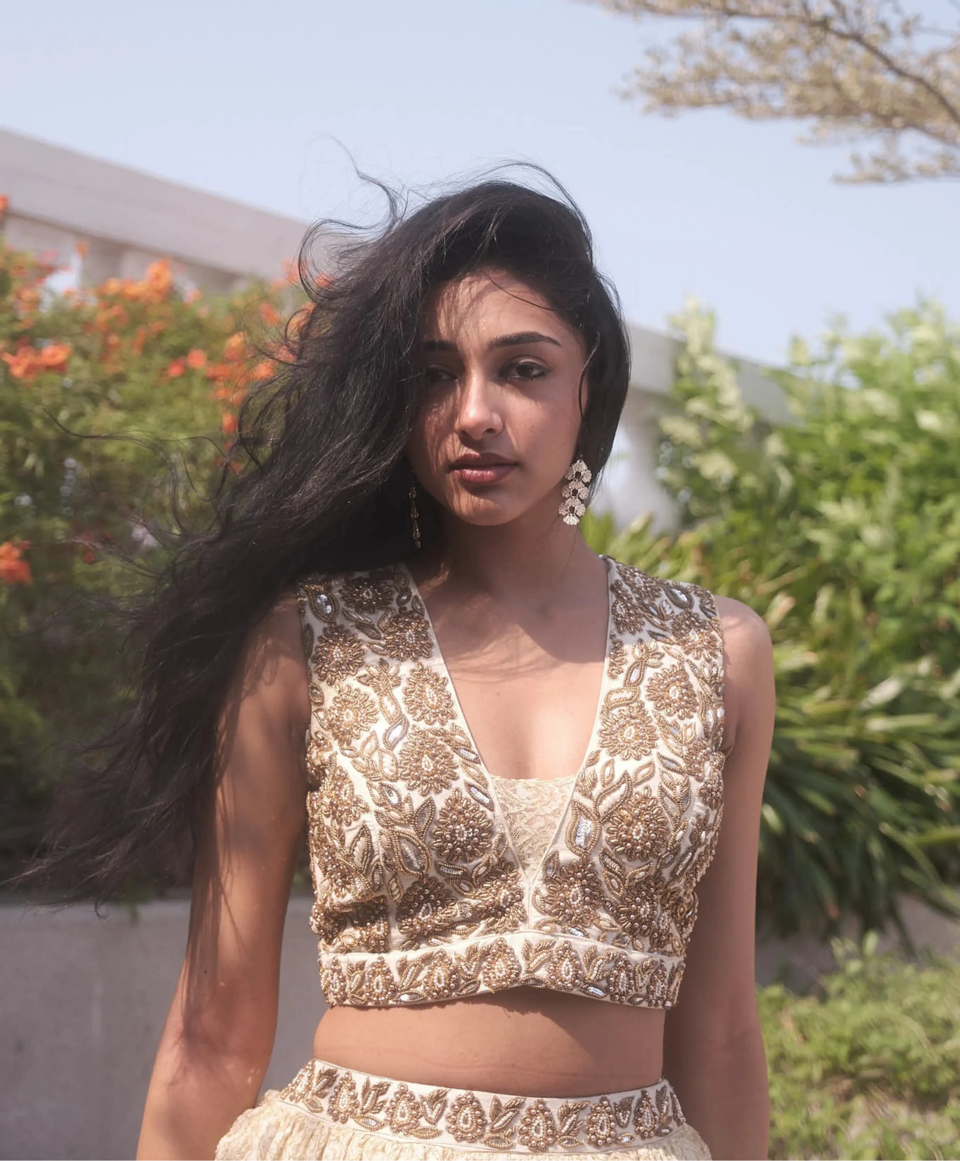 Actress & dancer Preity Mukhundhan during photoshoot in a plunge neck raw silk ivory crop-top bralette and layered skirt in brasso fabric with self work by team Archana Karthick.