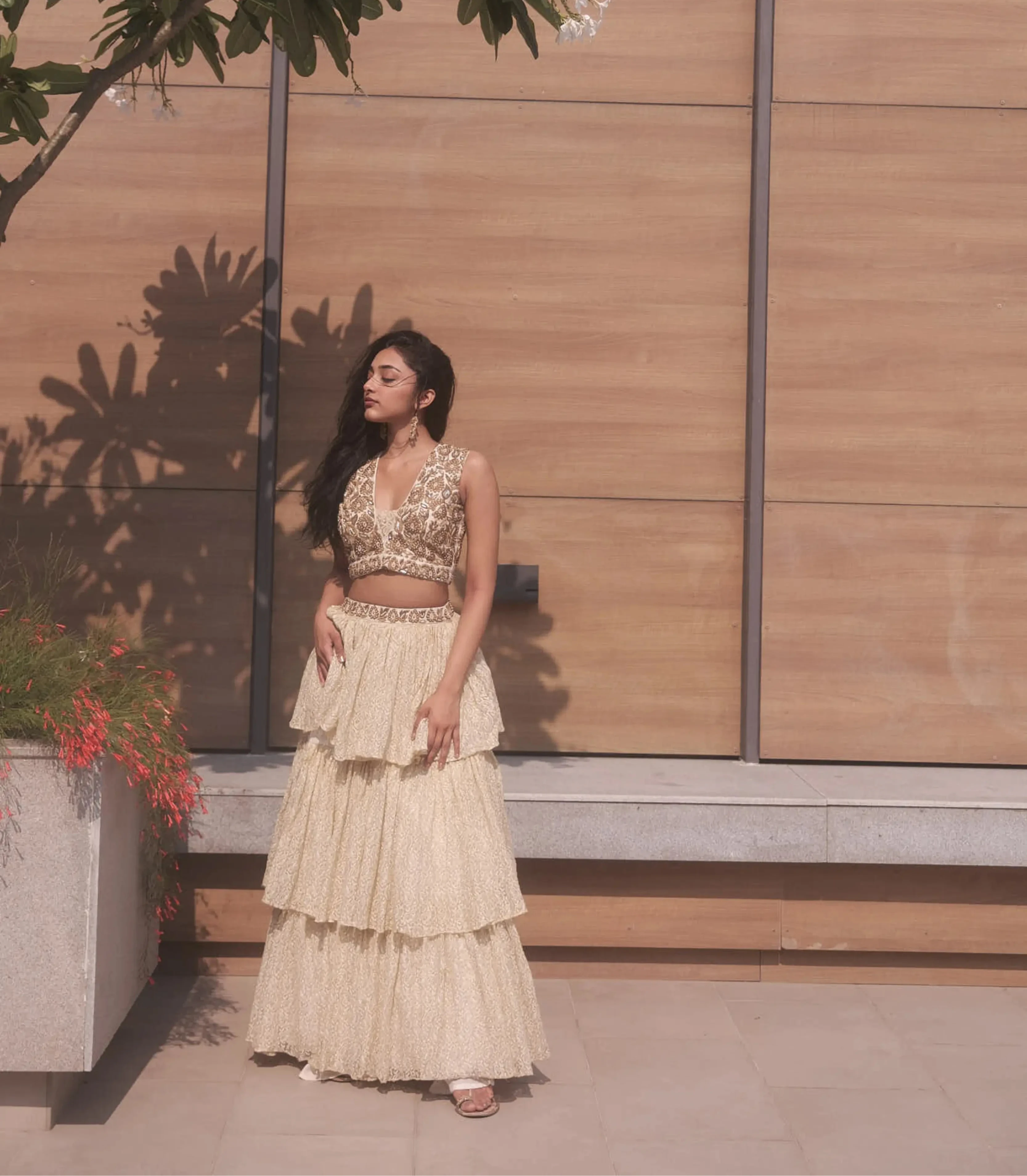 Actress & dancer Preity Mukhundhan in a plunge neck raw silk ivory crop-top bralette and layered skirt in brasso fabric with self work by team Archana Karthick.