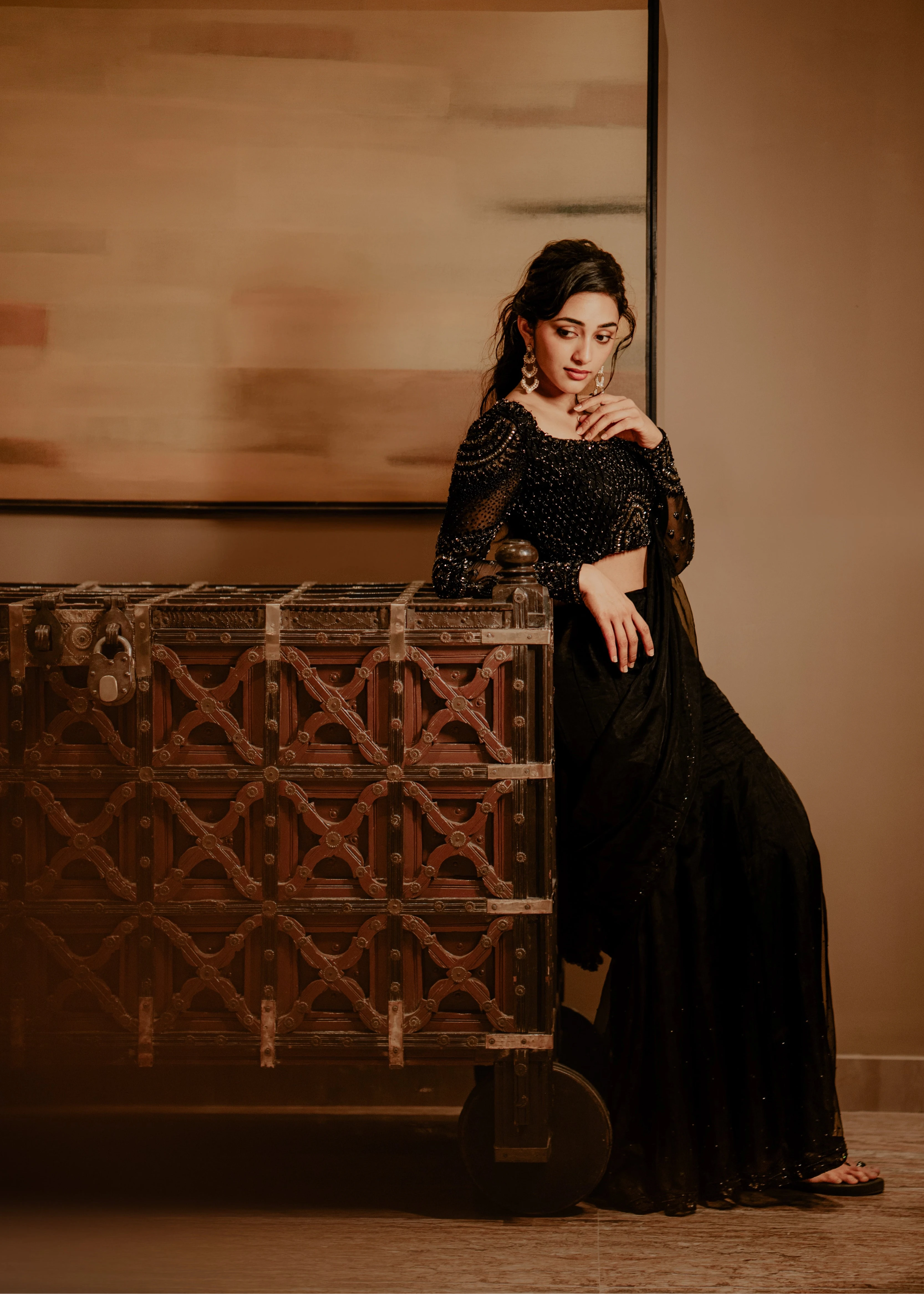 Actress & dancer Preity Mukhundhan leaning in "The Black Mermaid" black mermaid lehenga saree from Archana Karthick's collection.