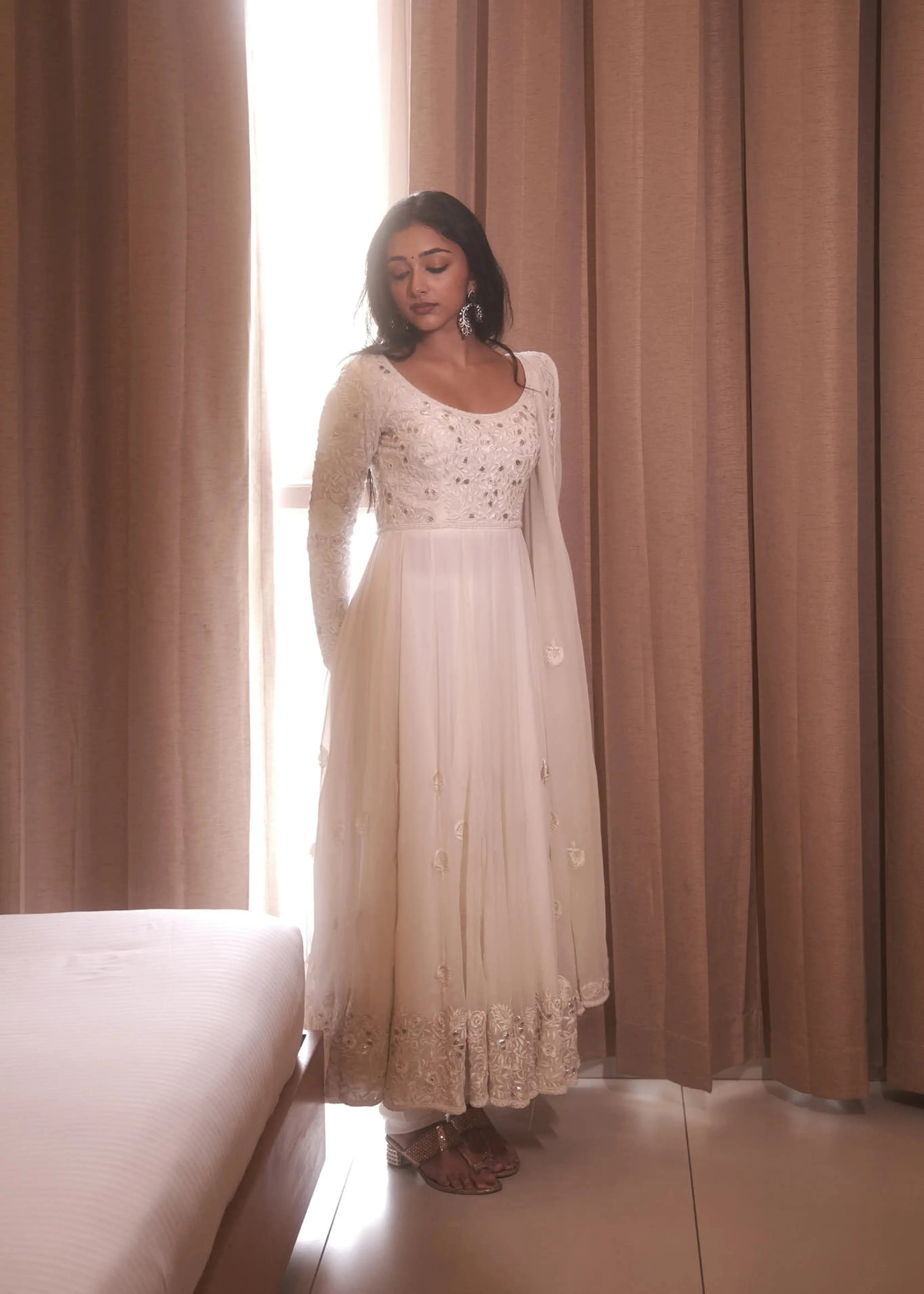 Actress & dancer Preity Mukhundhan posing for photoshoot in a white georgette anarkali intricately handcrafted with gotapati, resham (chikanakri work) by team Archana Karthick.