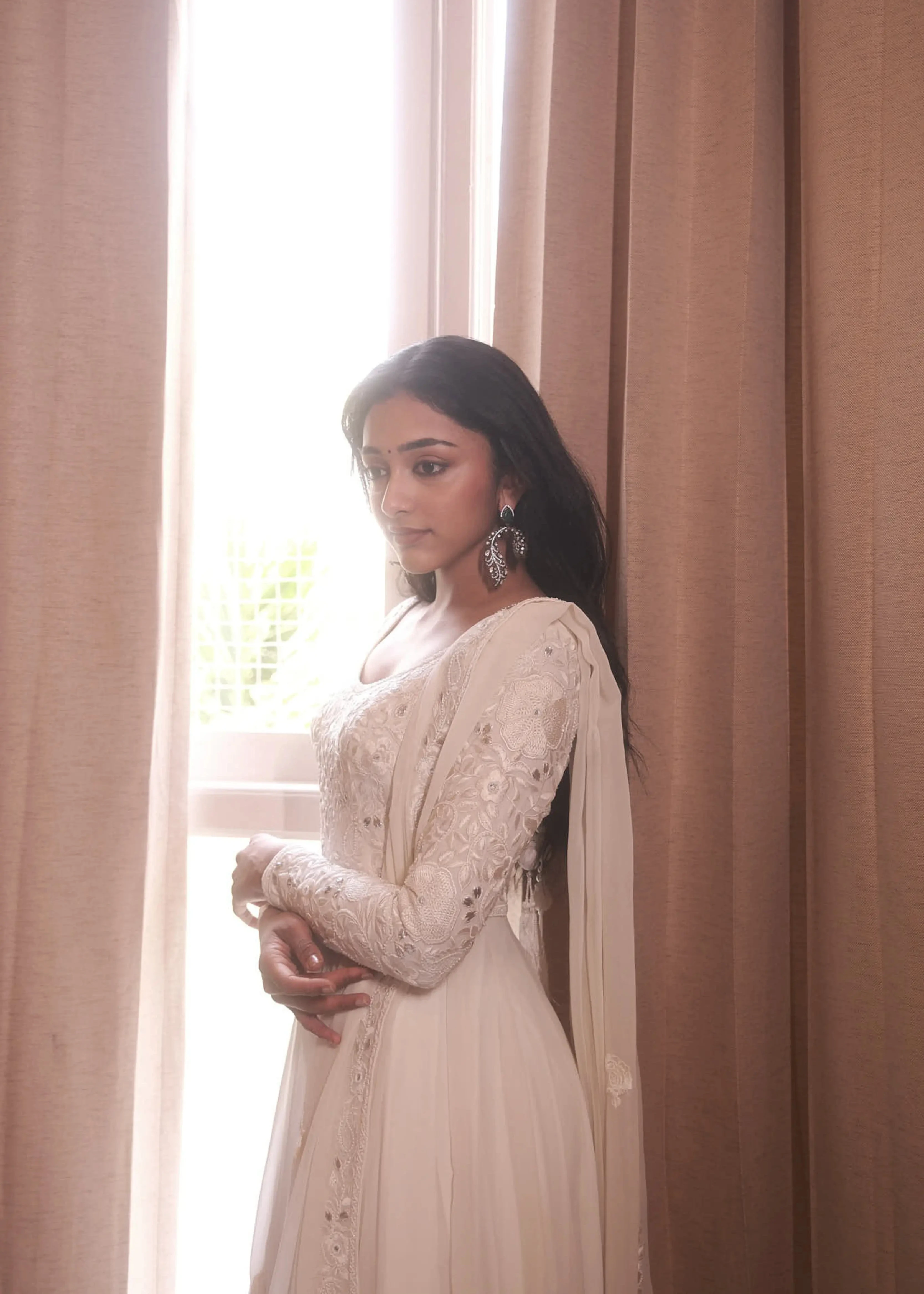 Actress & dancer Preity Mukhundhan posing in a white georgette anarkali intricately handcrafted with gotapati, resham (chikanakri work) by team Archana Karthick.