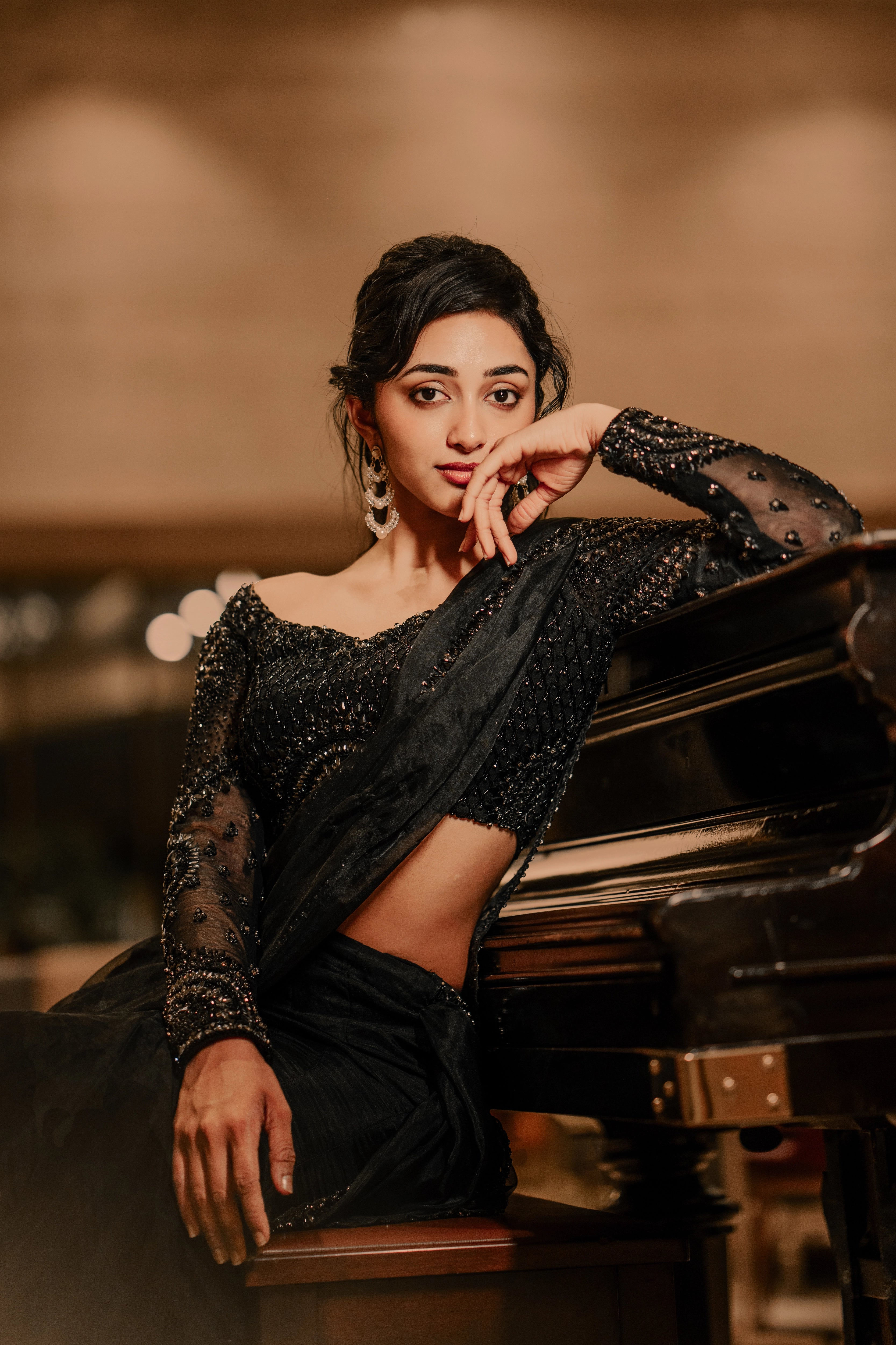 Actress & dancer Preity Mukhundhan smiling in a photoshoot in "The Black Mermaid" black mermaid lehenga saree from Archana Karthick's collection.