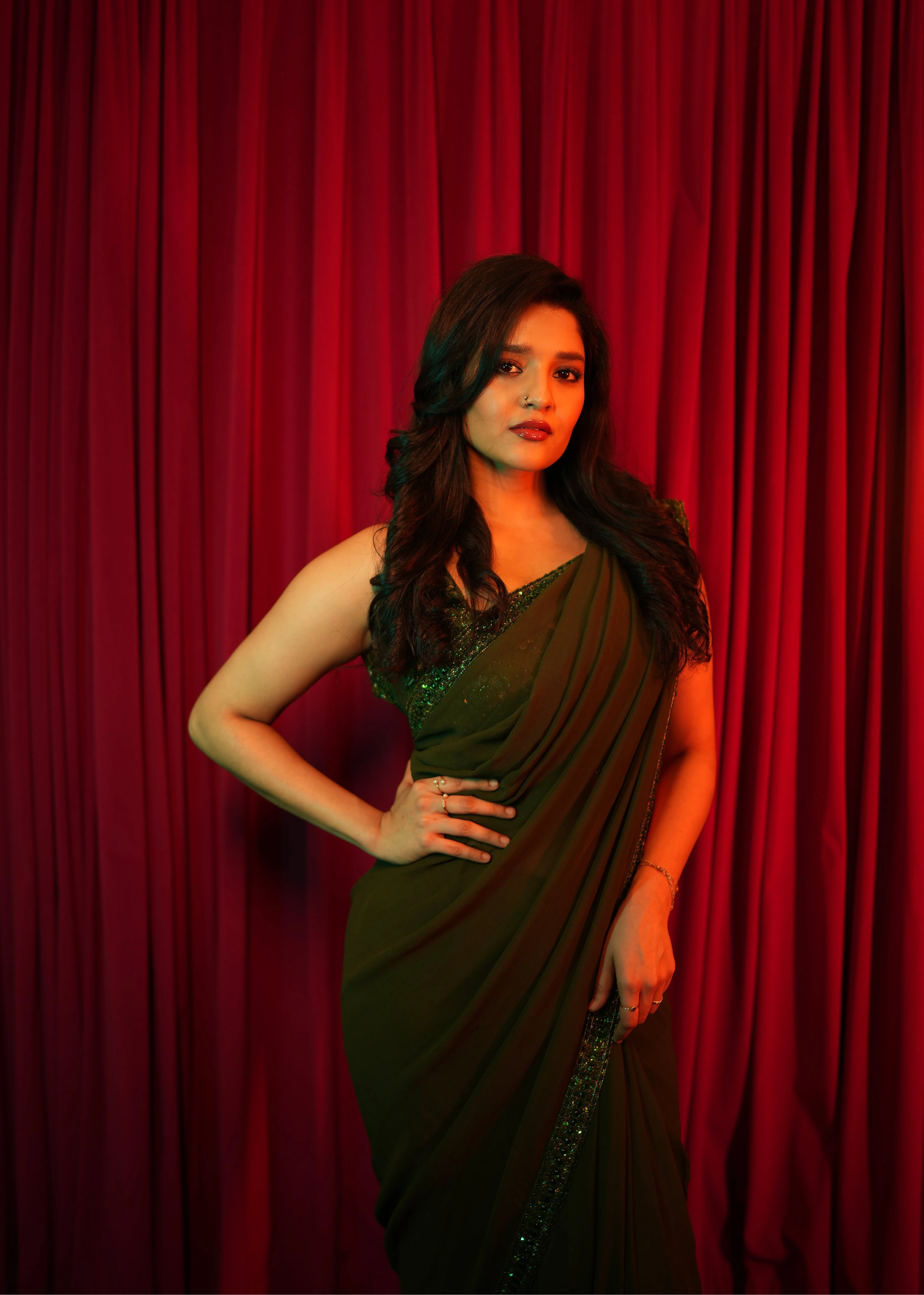 Actress & professional boxer Ritika Singh during photoshoot in a moss green georgette saree intricately handcrafted with sequins and cutdana by team Archana Karthick.