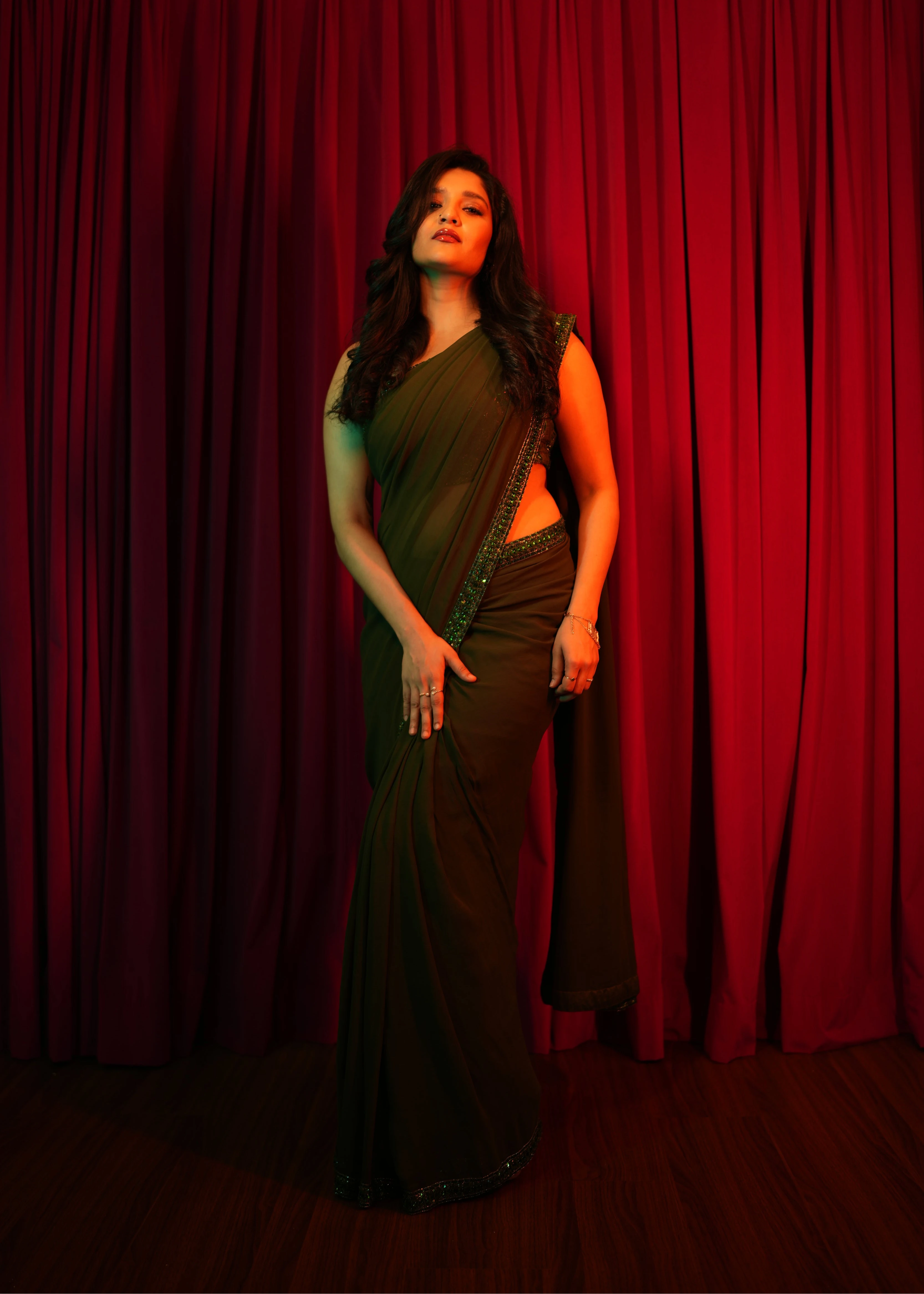 Actress & professional boxer Ritika Singh in a moss green georgette saree intricately handcrafted with sequins and cutdana by team Archana Karthick.