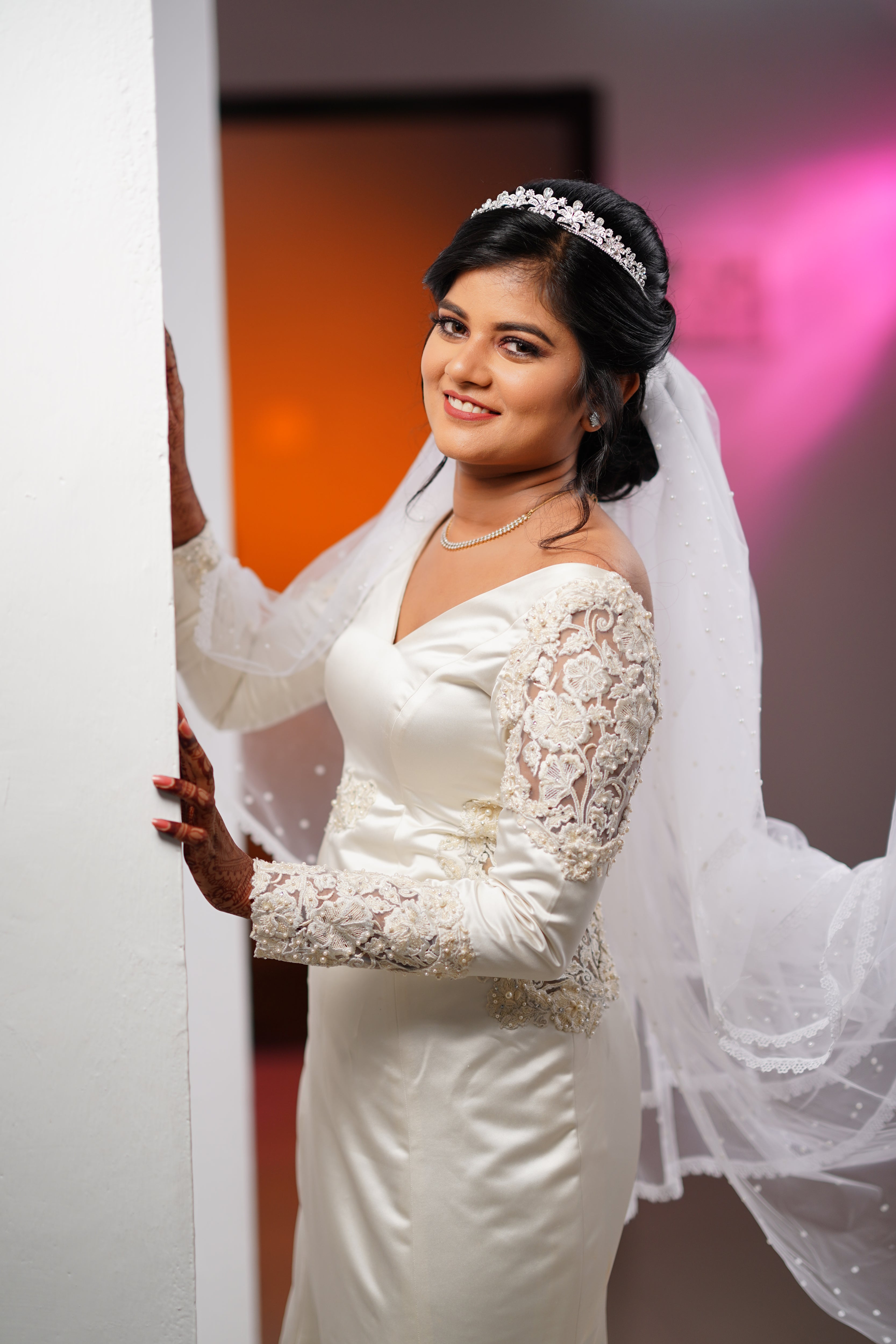 Adeal Josh in a white gown for her church wedding, handcrafted by team Archana Karthick.