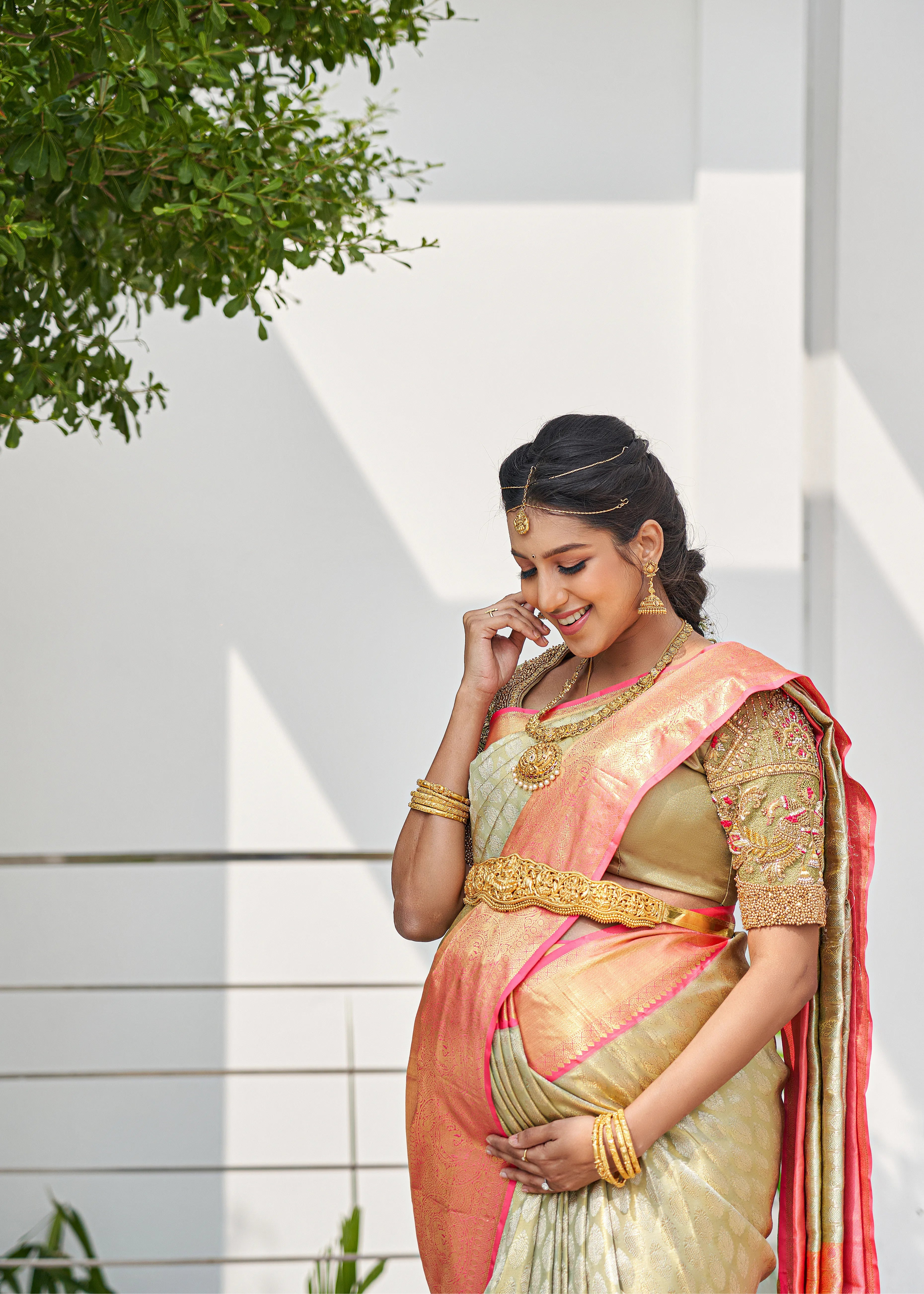Ashwini Kumar, one of the mommies to be for whom Archana Karthick designed the blouse for her baby shower. She is looking down and smiling.