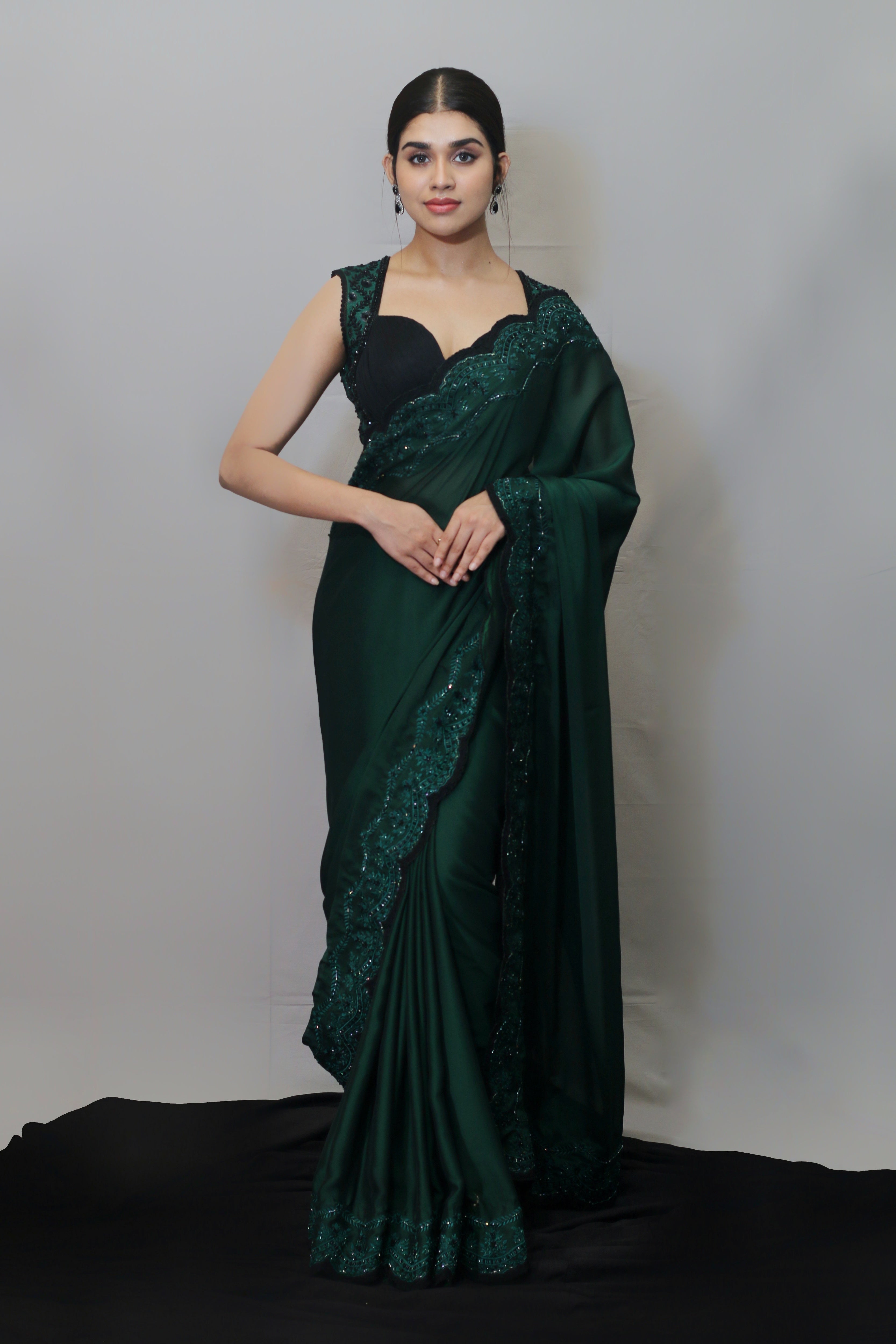Actress Meenakshi Govindarajan in bottle green satin georgette saree set