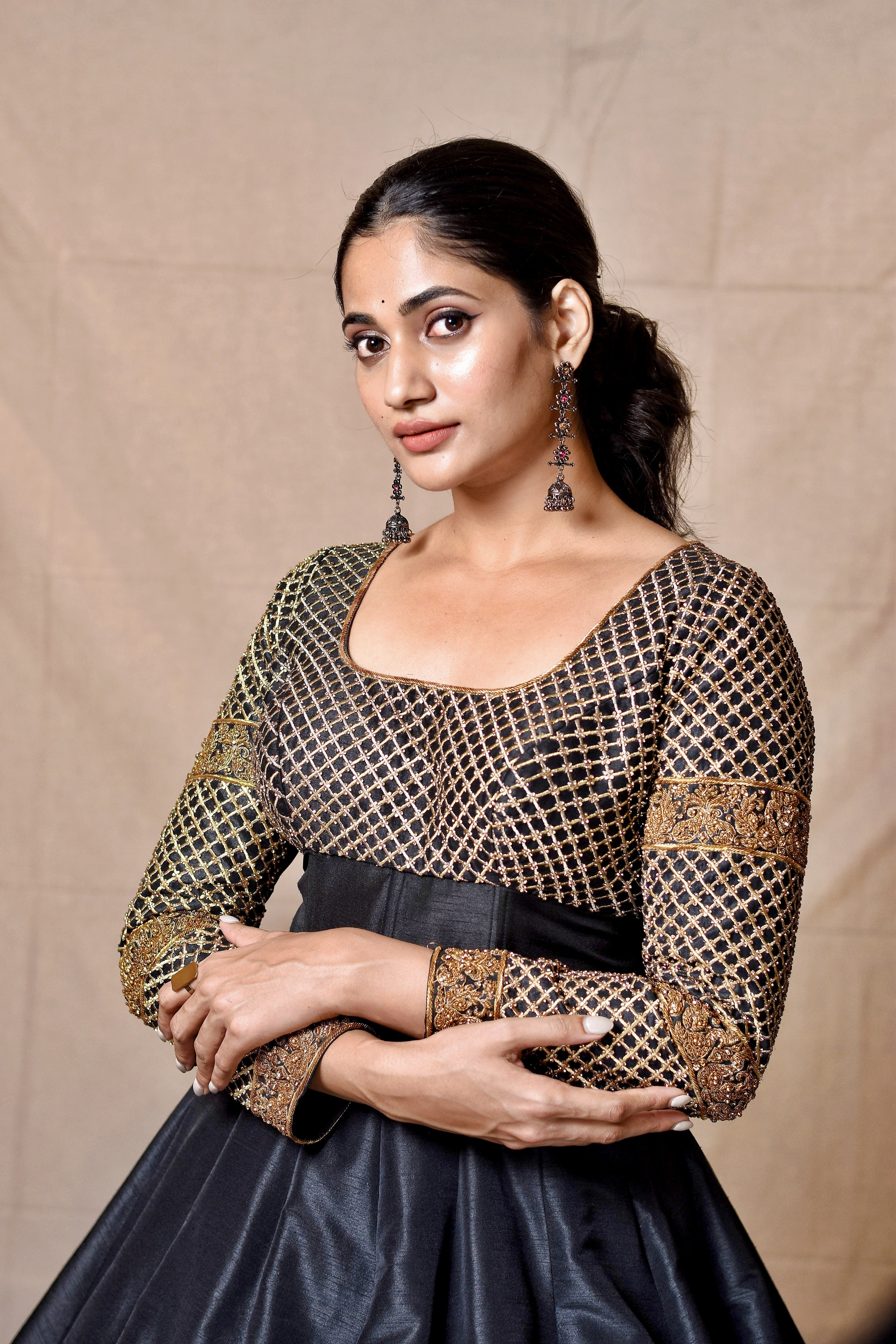 Bigg Boss fame and Actress Losliya Mariyanesan in Black Designer Anarkali by Archana Karthick looking left at camera with both hands on each other