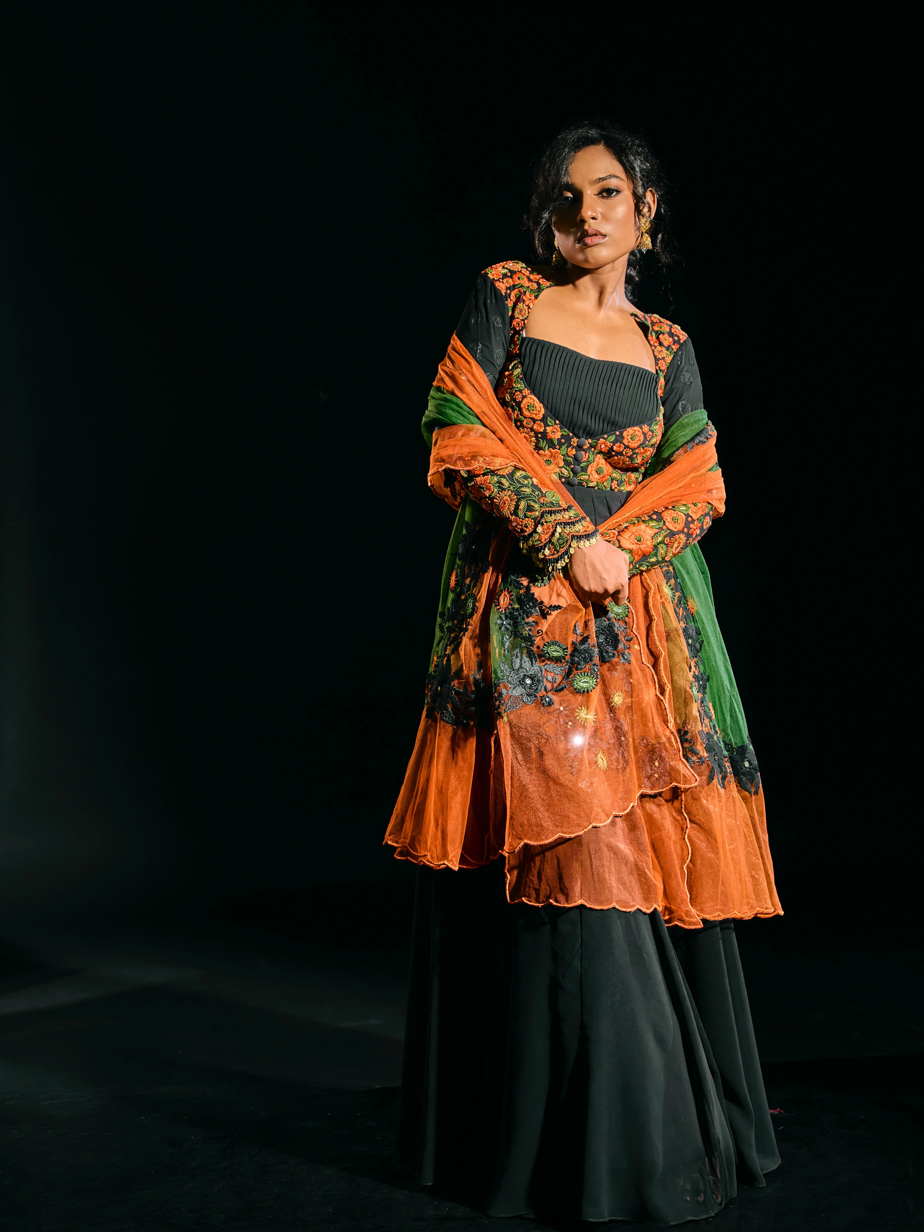 Black anarkali with an orange green dupatta, handcrafted with resham, mirror and metal coins for "HAZE" - A/W'25 capsule collection by Archana Karthick.
