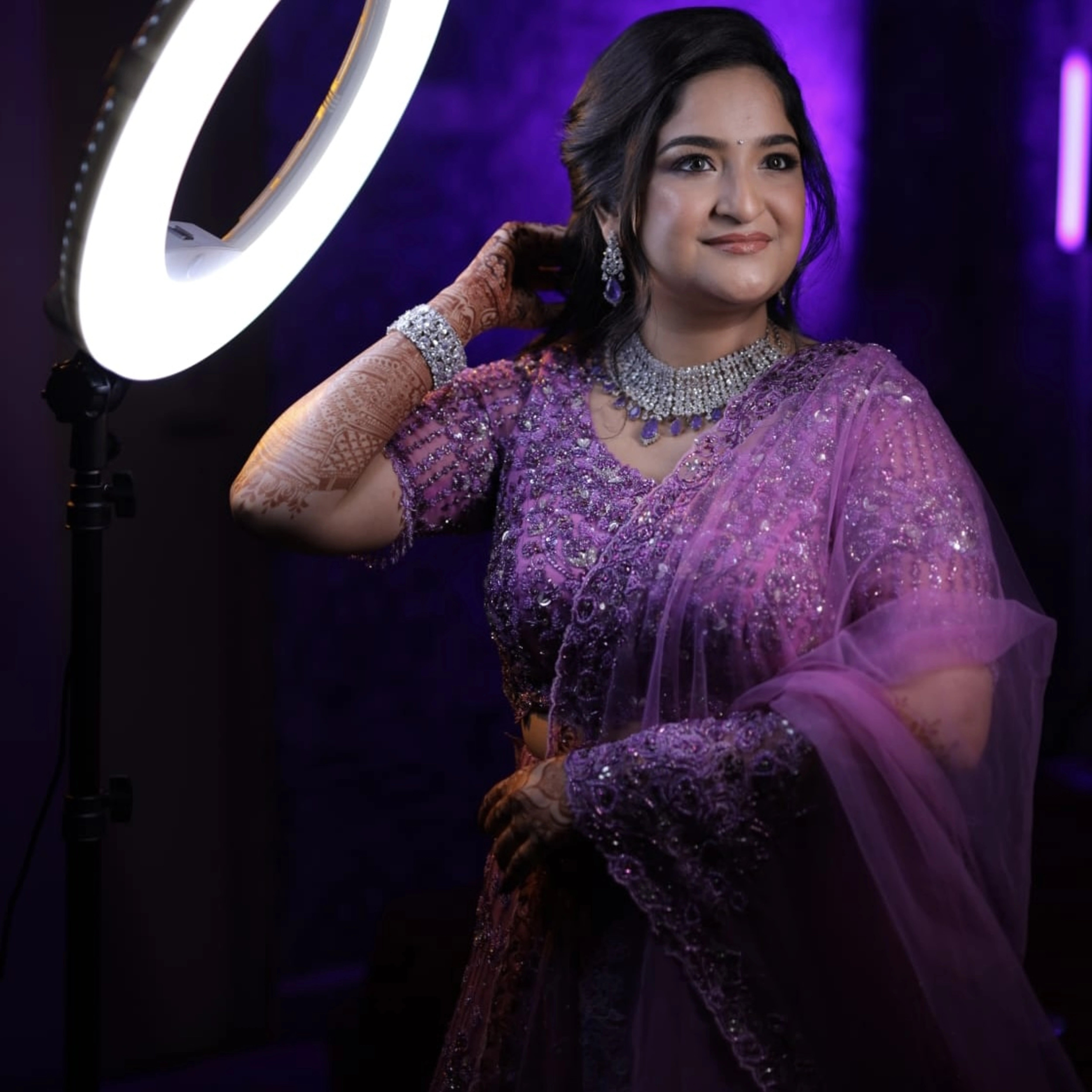 Bride Aarthi from USA smiling in a lavender lehenga by Archana Karthick