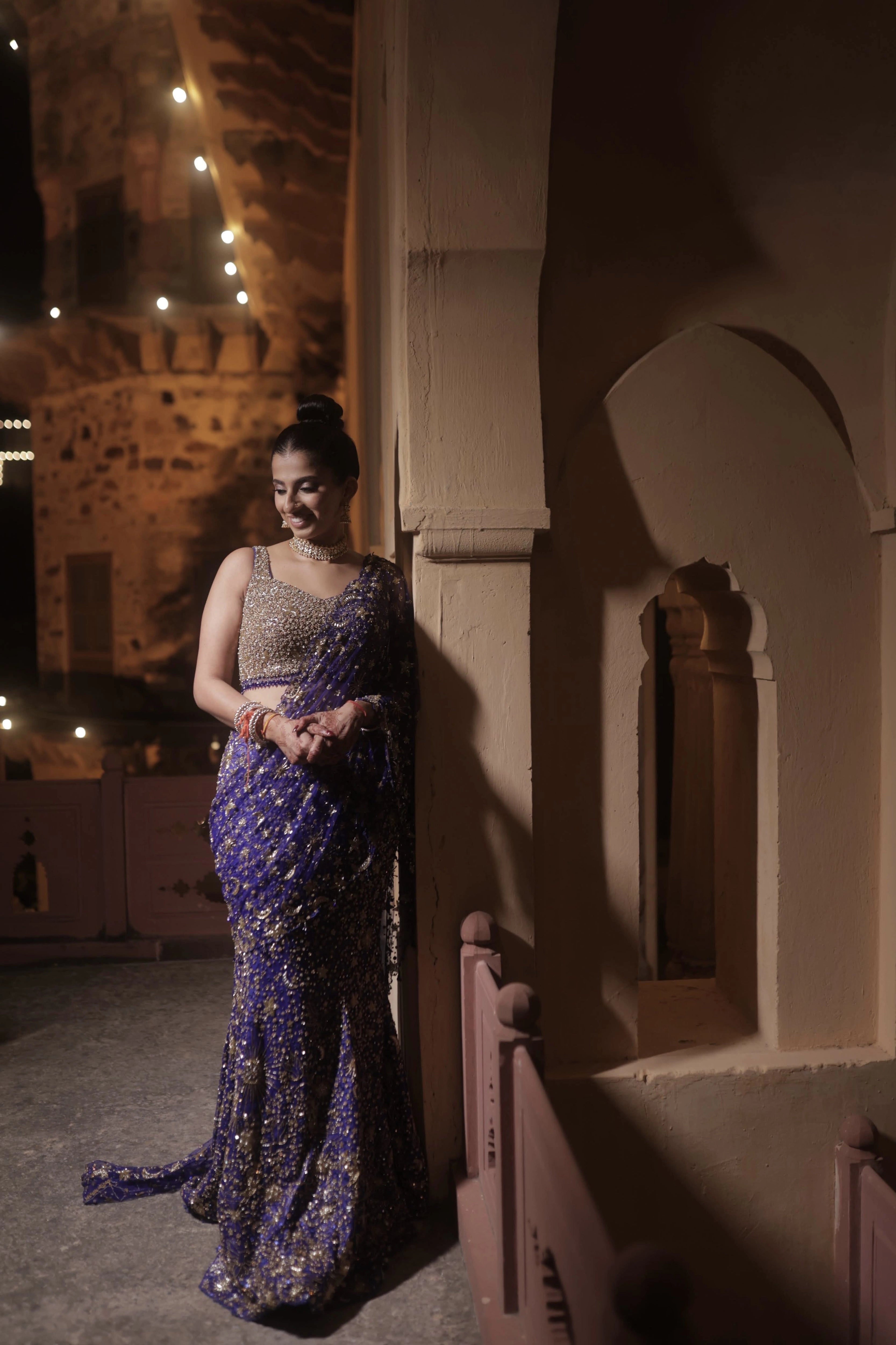 Bride Aashi Pal in a midnight blue tulle draped lehenga, handcrafted by team Archana Karthick.