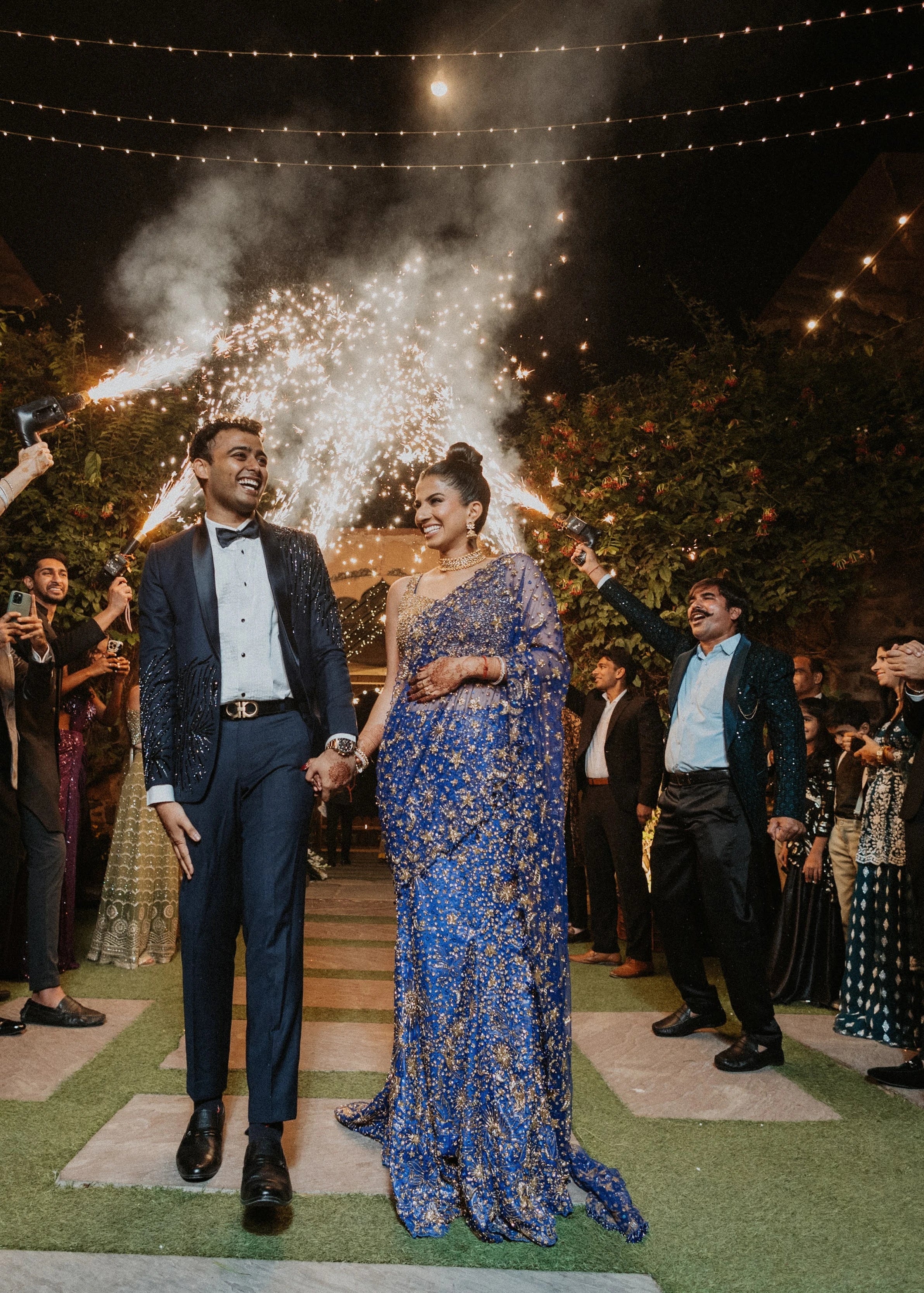 Bride Aashi Pal smiling in a midnight blue tulle draped lehenga, handcrafted by team Archana Karthick.