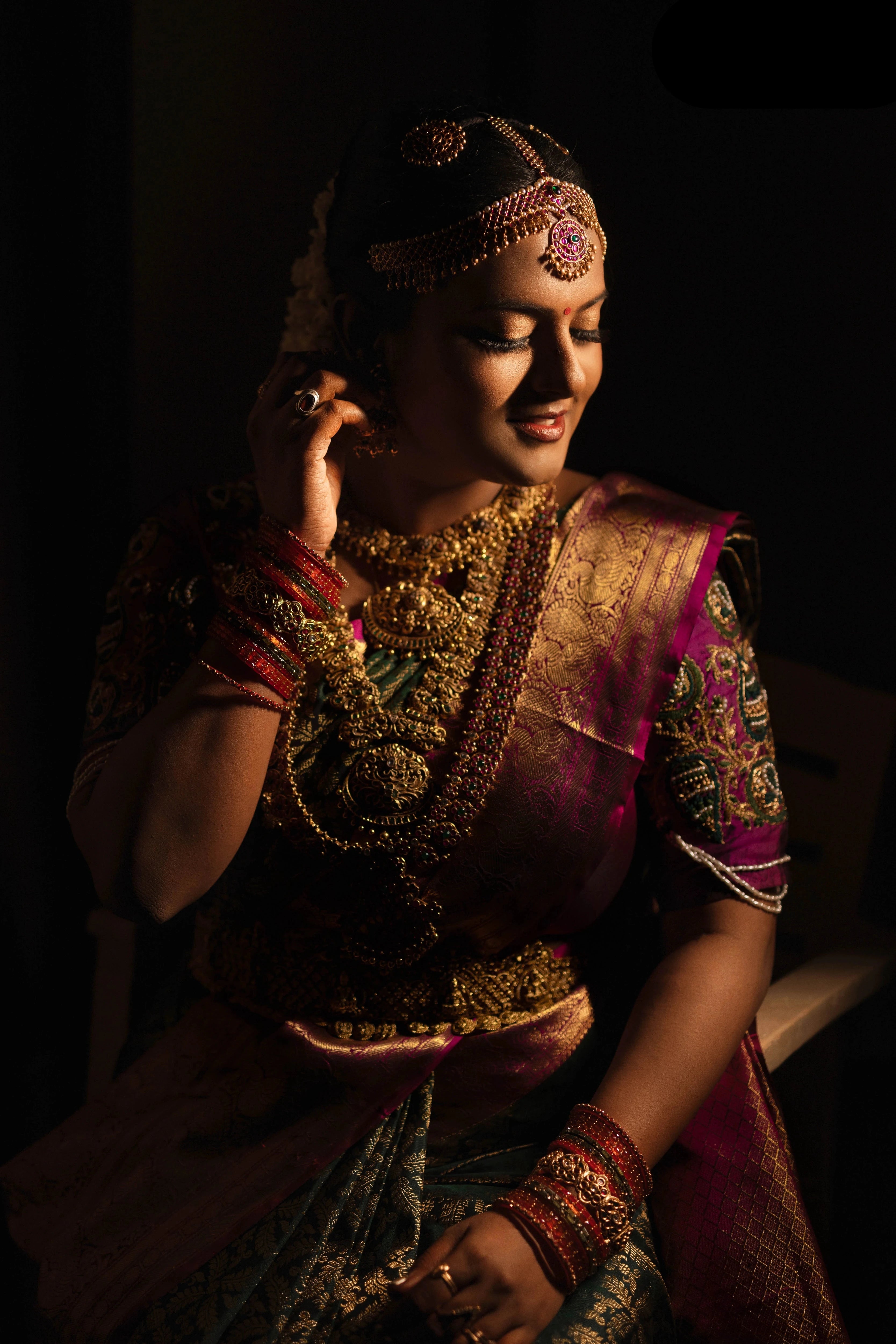 Bride Amirtha in a dark magenta silk blouse by team Archana Karthick.