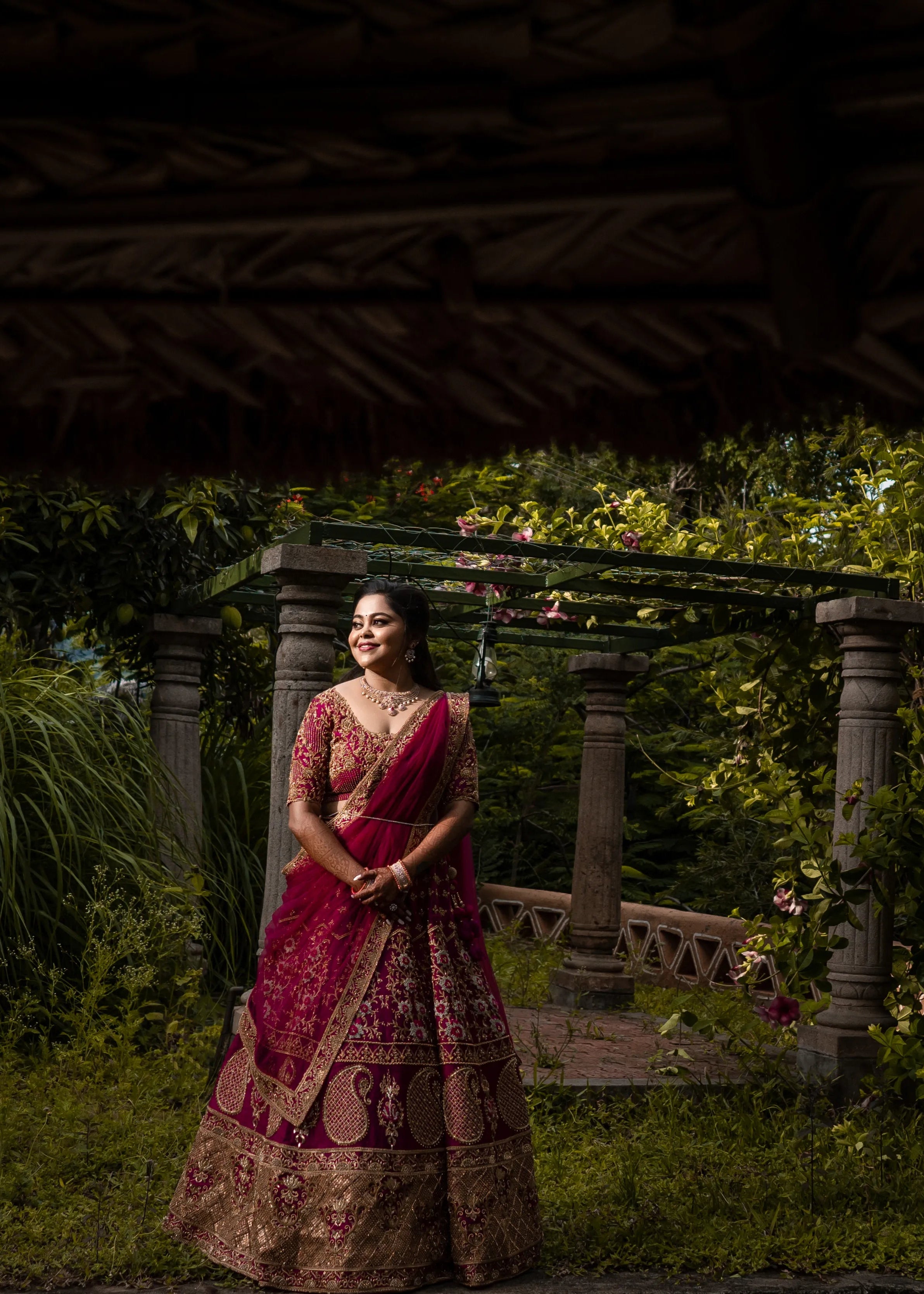 Bride Anjana from coimbatore in a magenta red raw silk bridal lehenga designed by Archana Kartrhick.