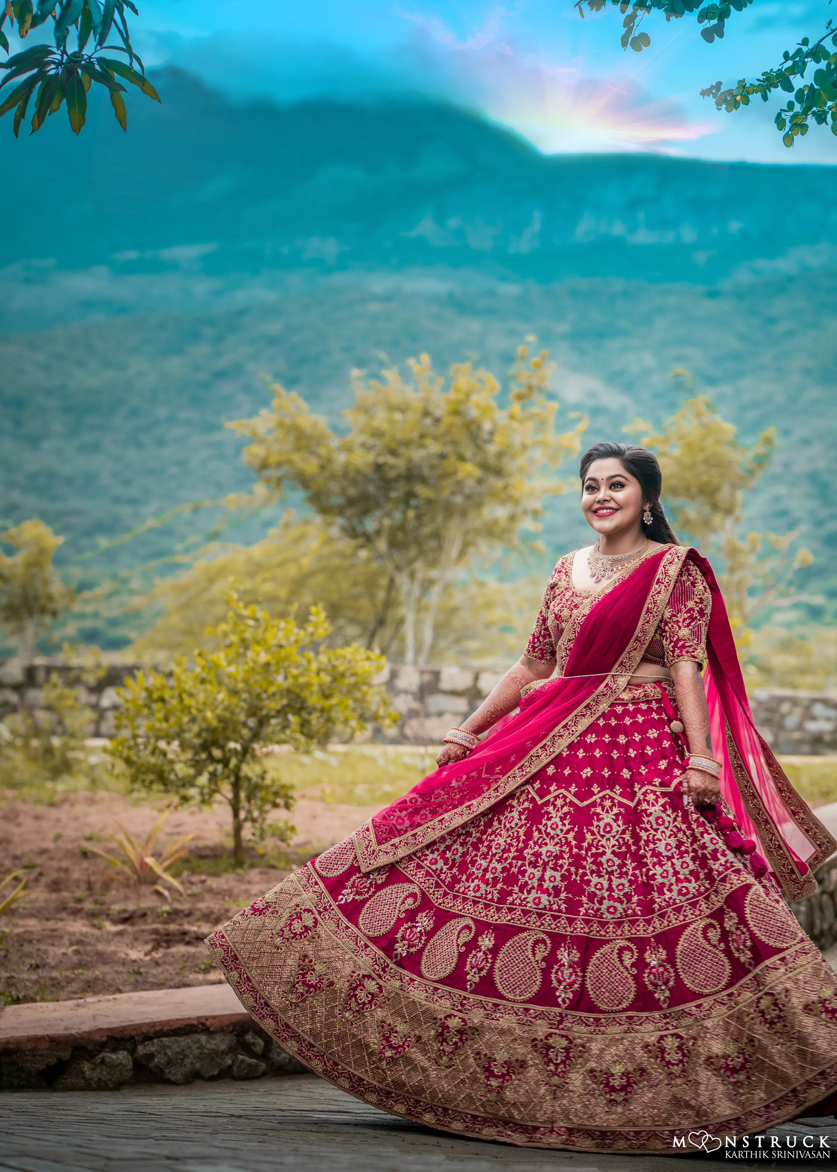 Bride Anjana from coimbatore twirling in a magenta red raw silk bridal lehenga designed by Archana Kartrhick.