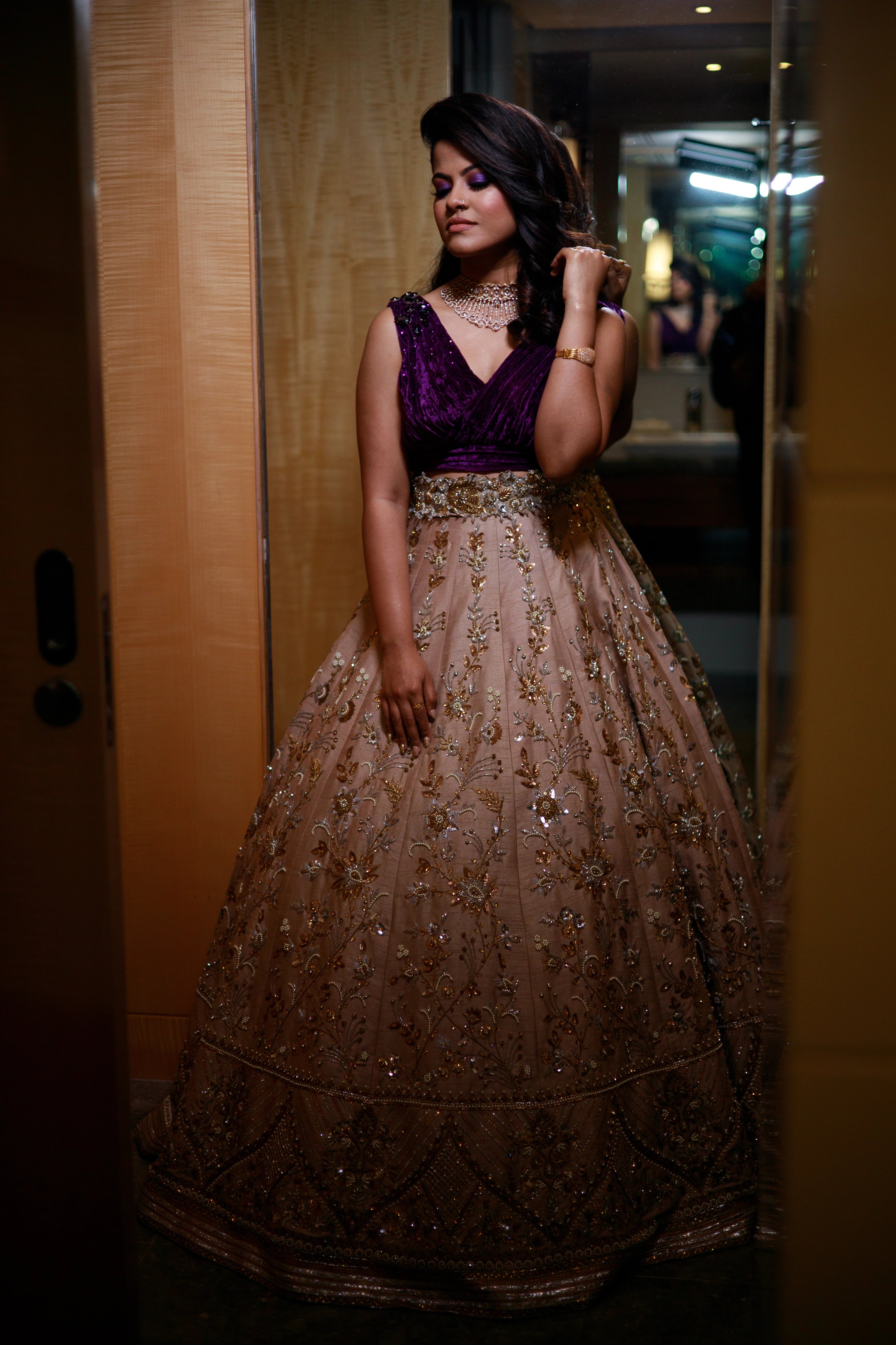 Bride Anu from Kerala in a purple & beige lehenga, handcrafted by team Archana Karthick.