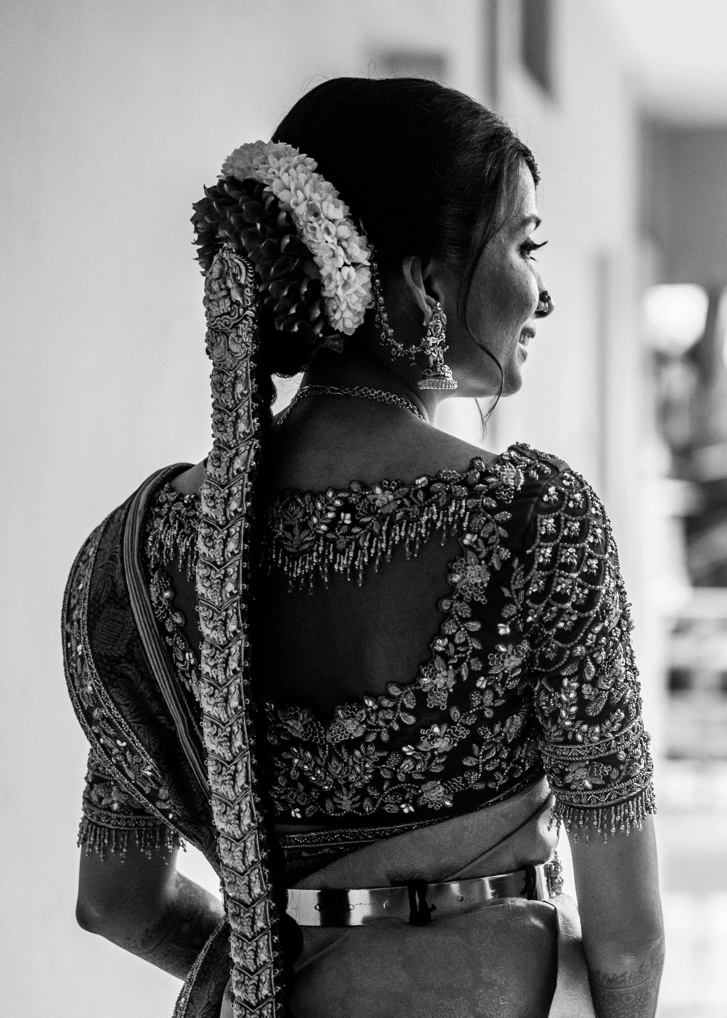 Bride Anusha K showcasing back blouse design in a wine red concept raw silk blouse, veil and saree border, handcrafted with zardosi, beads, resham, crystals, sequins etc by Archana Karthick.