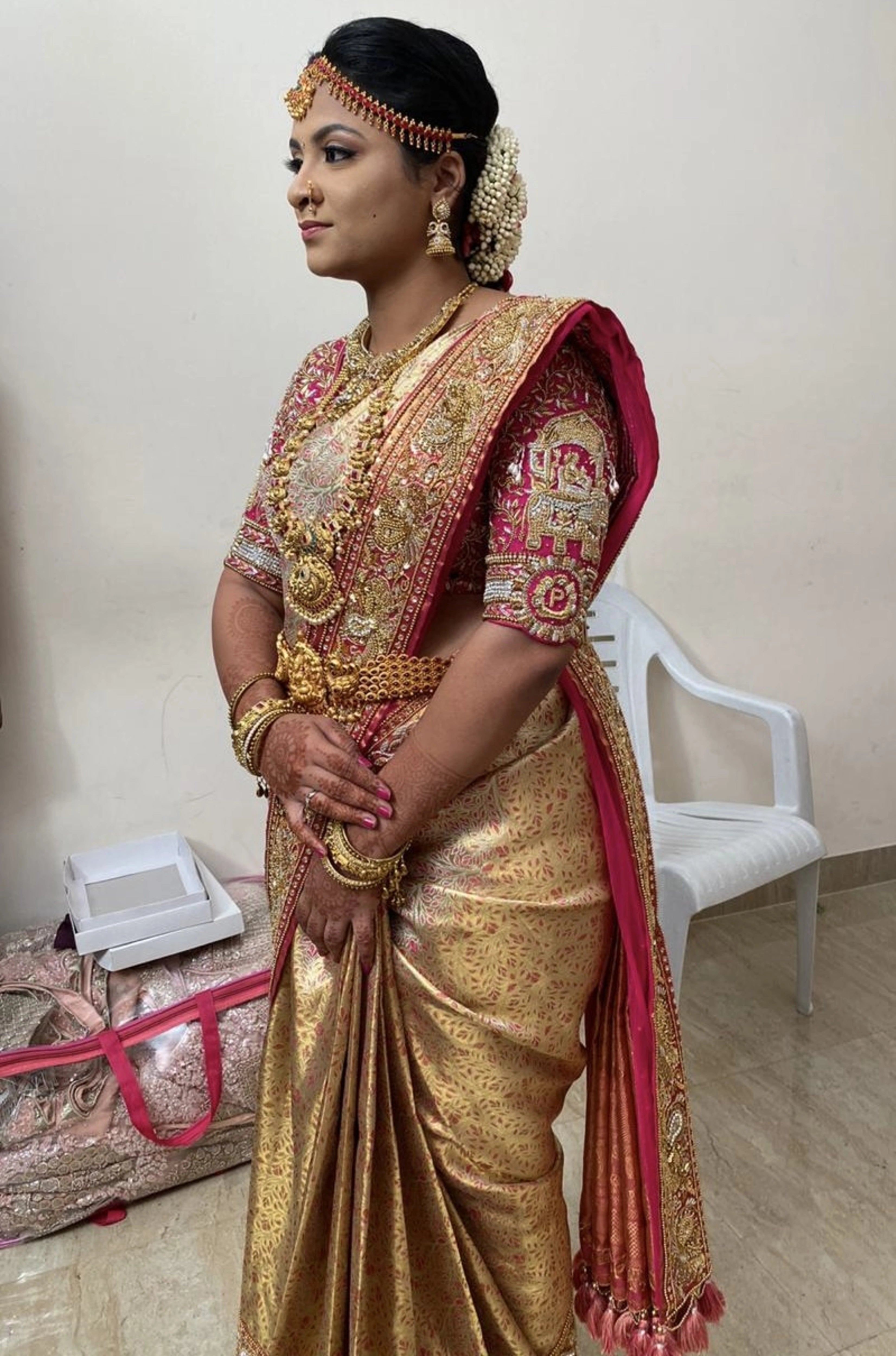 Bride Barani Lekha posing in an intricately handcrafted pink silk blouse and saree border with zardozi, beads, stones, sequins and hangings by team Archana Karthick.