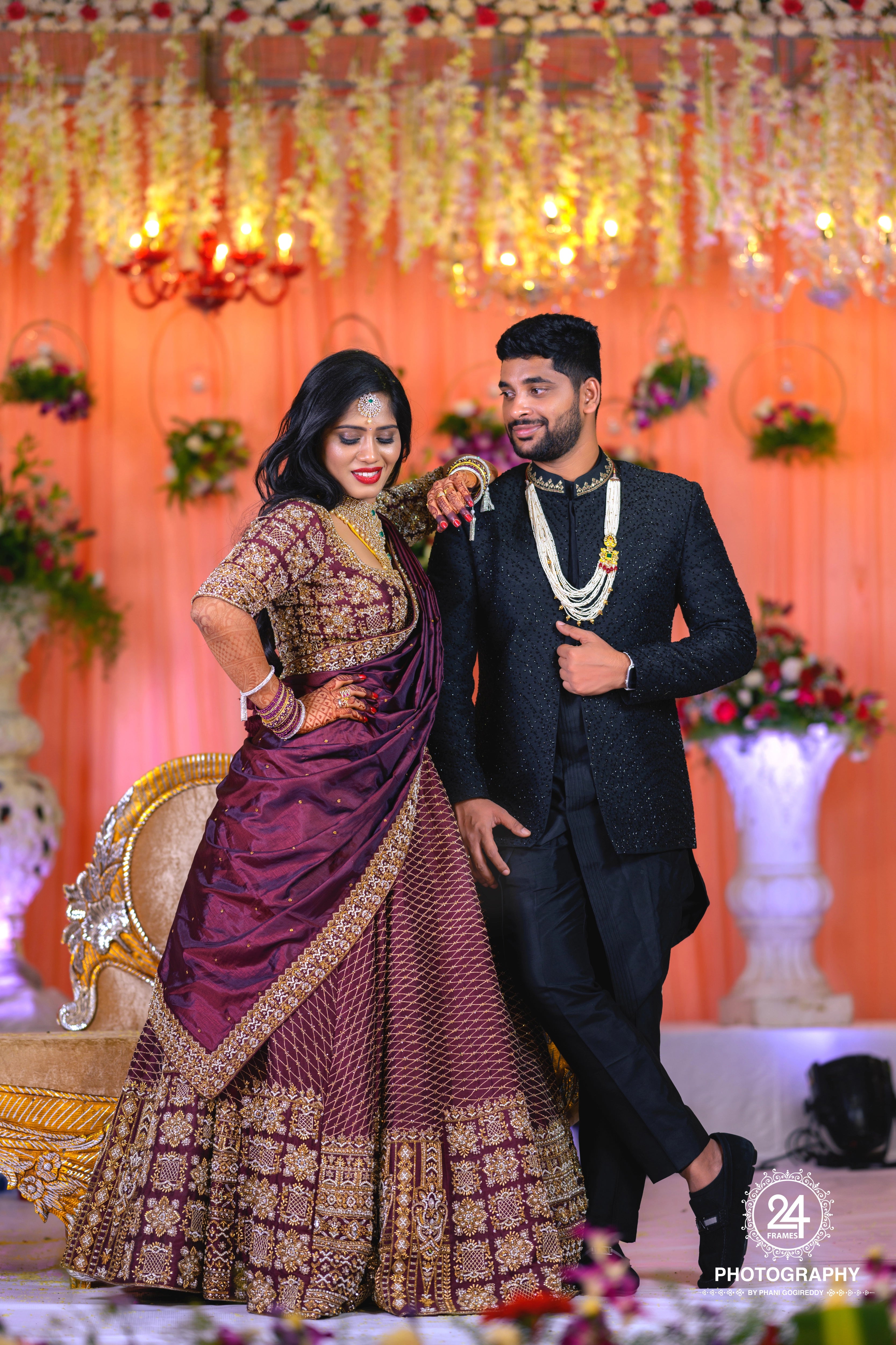 Bride Chaitanya Reddy in a maroon raw silk reception lehenga, handcrafted by team Archana Karthick.