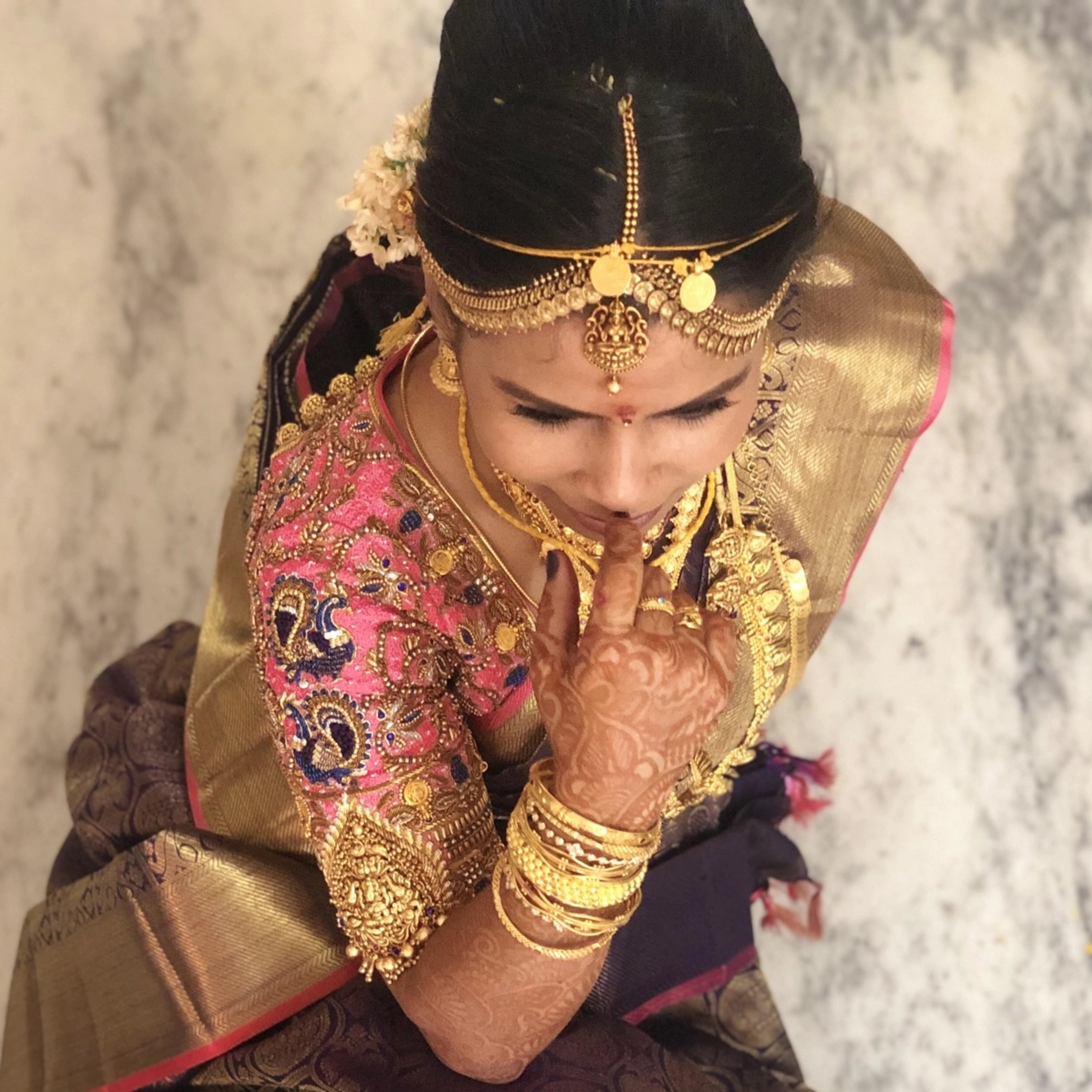 Bride Deepa in a pink raw silk palanquin concept blouse, handcrafted with stones, resham, zardozi, sequins, beads, cutdana and jhumkas by team Archana Karthick.
