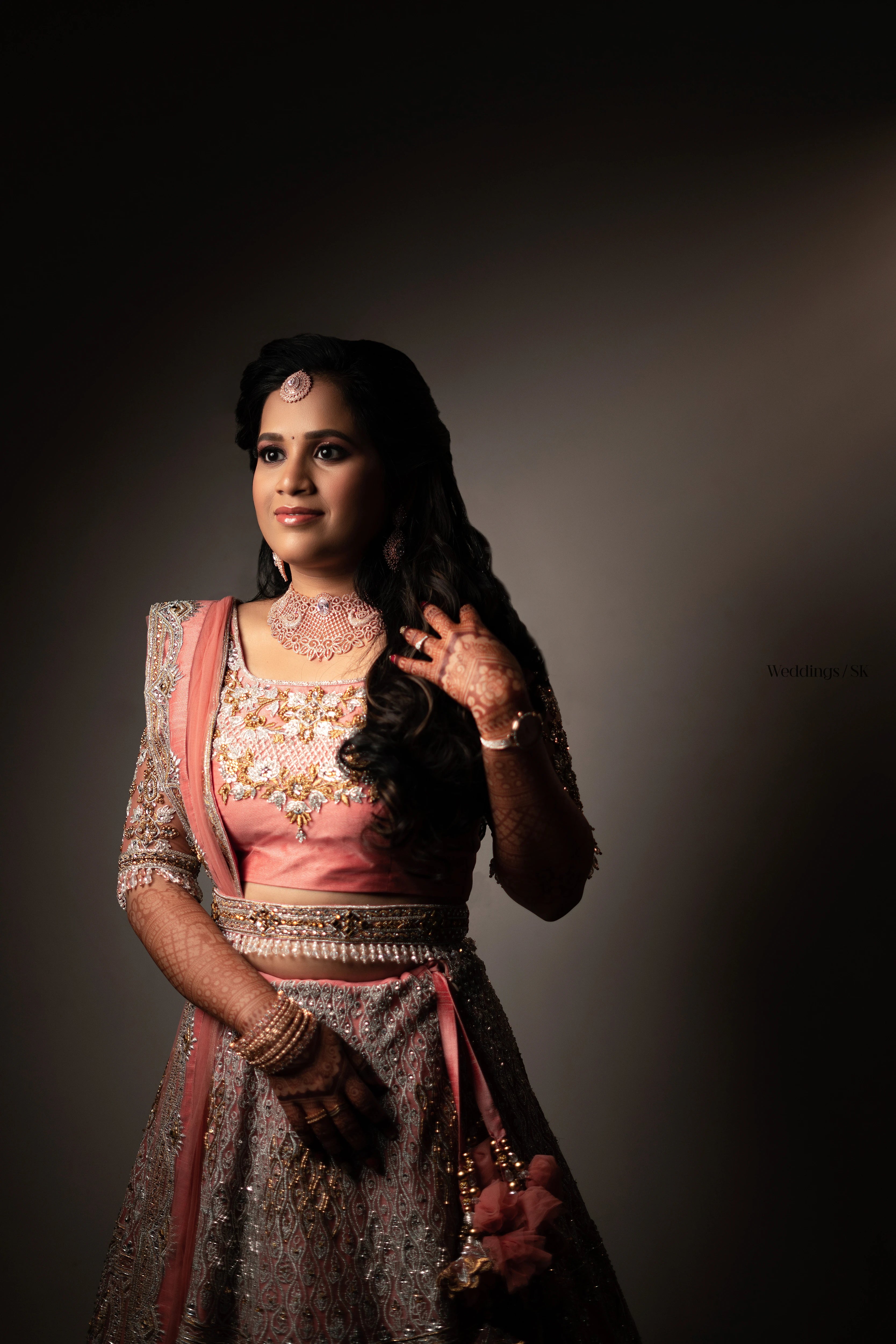 Bride Divya Gopinath from Portland, USA posing in a pink peach tulle lehenga, handcrafted team Archana Karthick.