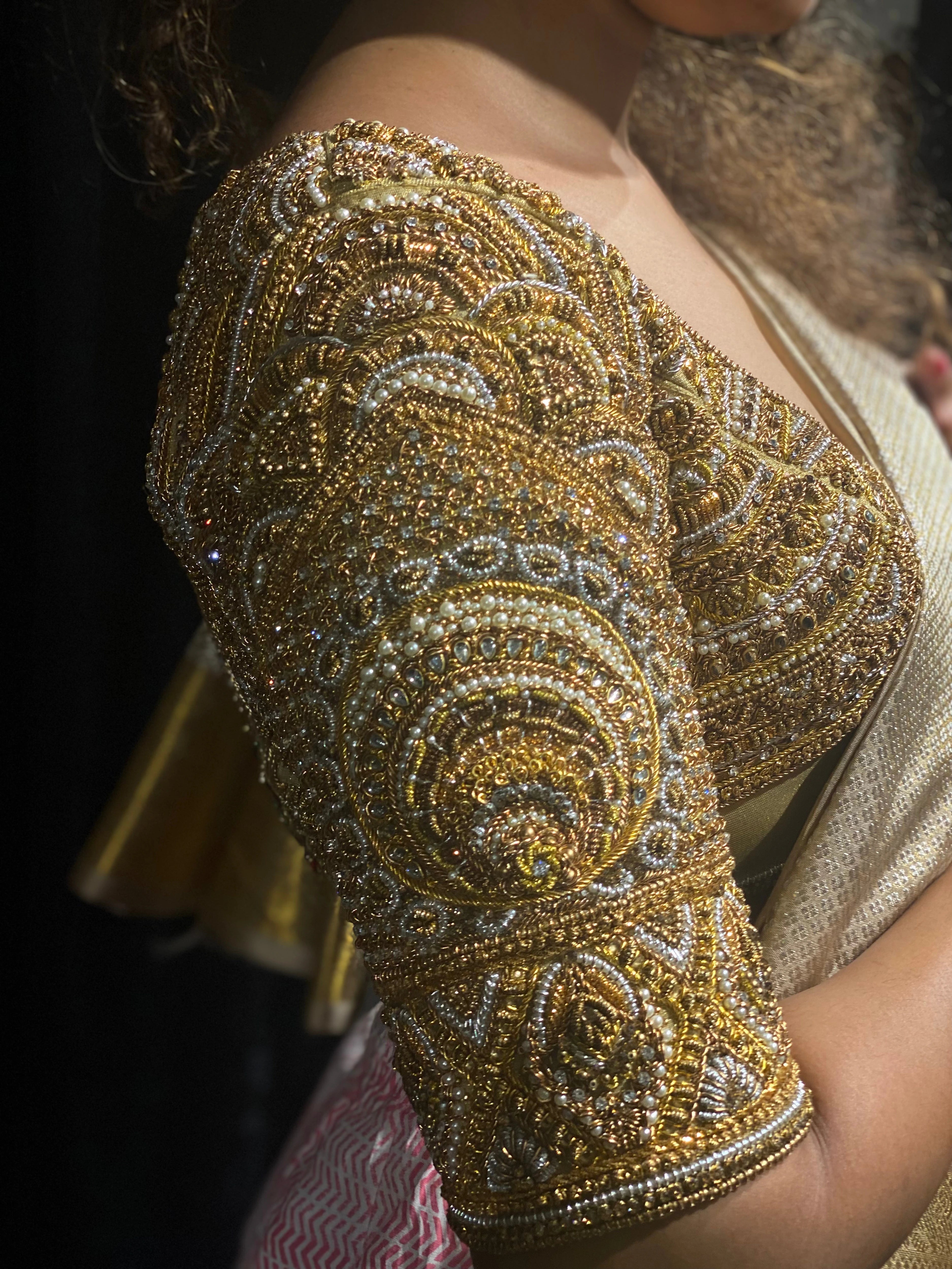 Bride Divya during fittings in a gold silk blouse handcrafted by team Archana Karthick.
